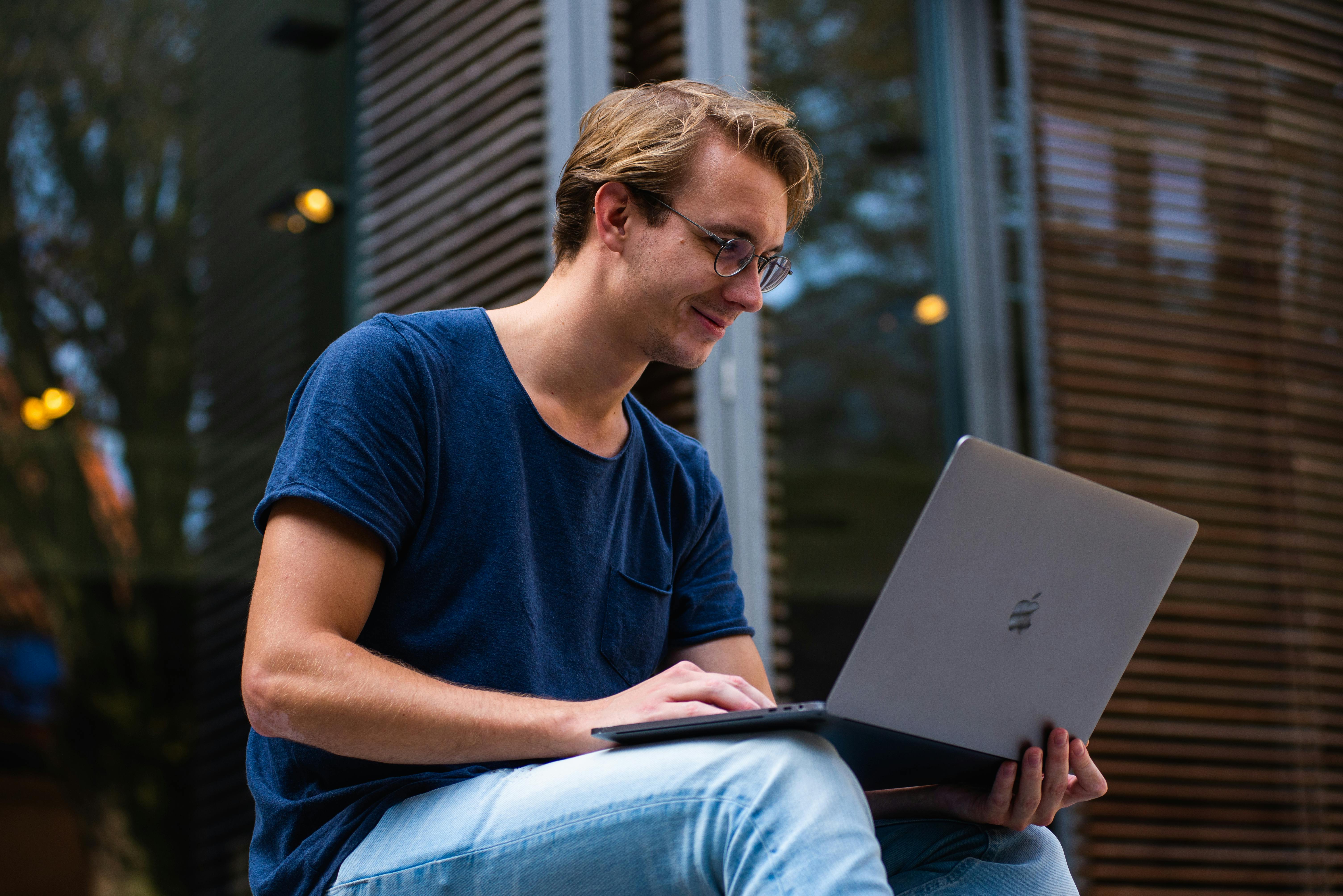 A young man using a laptop | Source: Midjourney