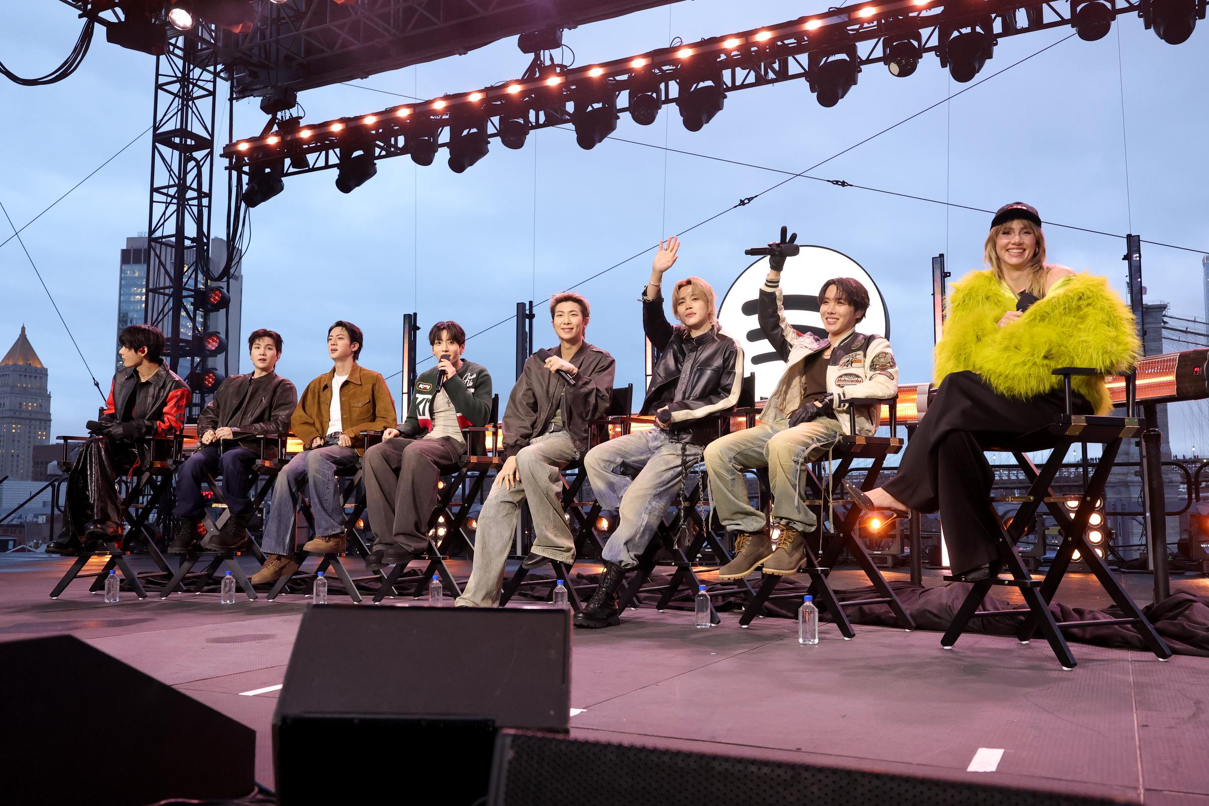 V, Suga, Jin, Jungkook, RM, Jimin and J-Hope of BTS and Suki Waterhouse speak onstage during Spotify x BTS: SWIMSIDE at Pier 17 on March 23, 2026 in New York City. | Source: Getty Images