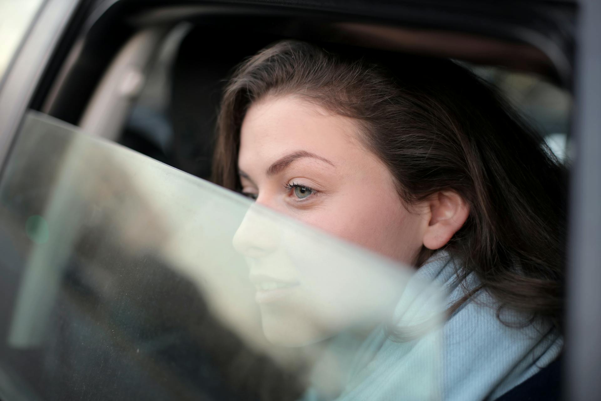 A woman looking out the car window | Source: Pexels