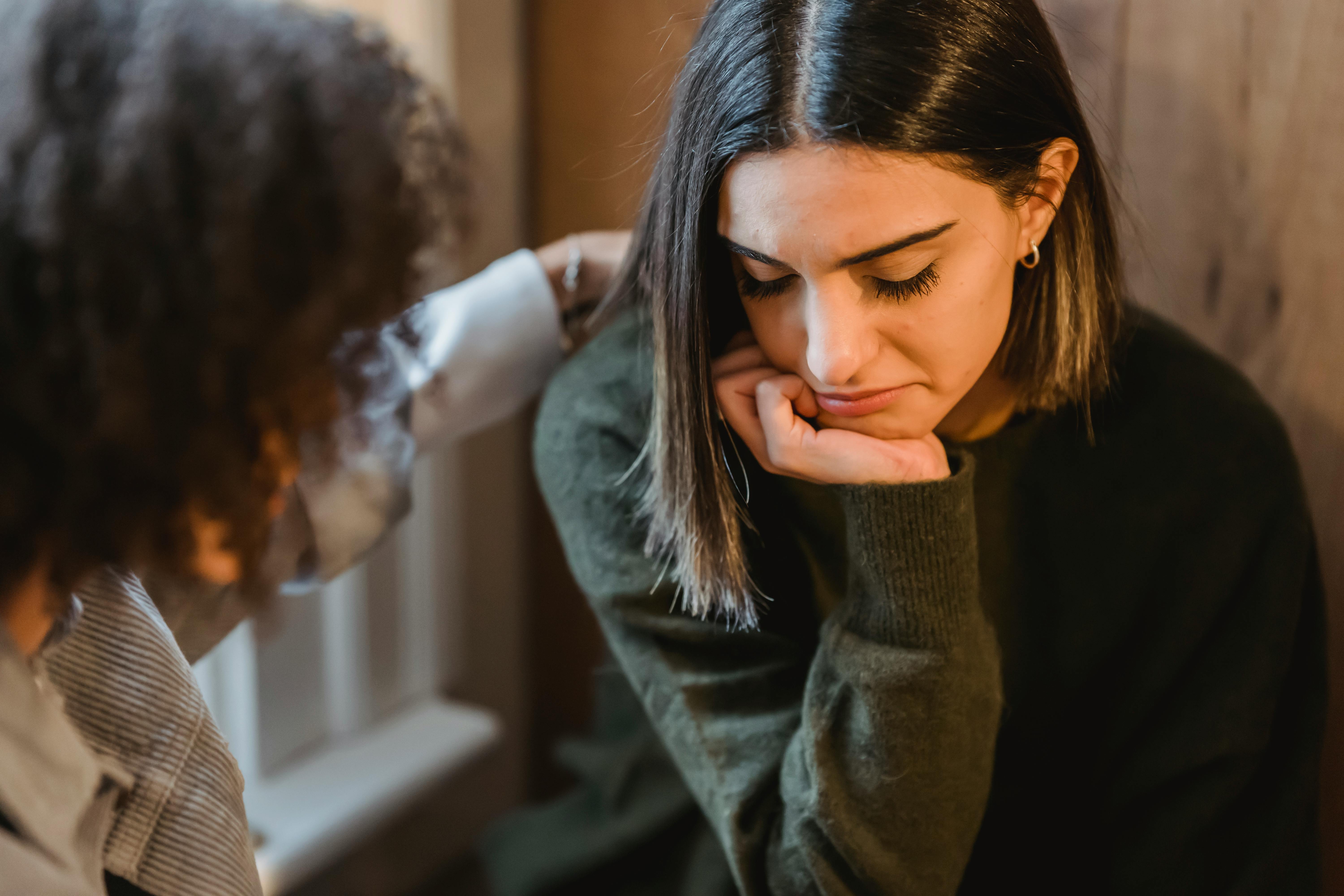 An upset woman being consoled by a friend | Source: Pexels