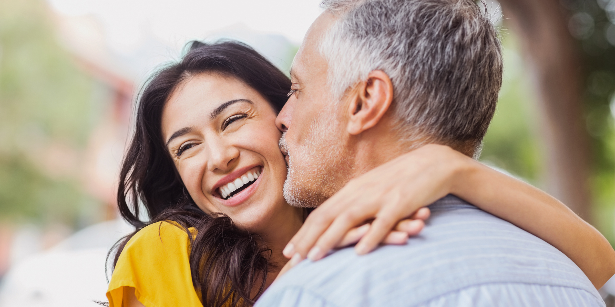 A man kisses his partner on the cheek | Source: Shutterstock
