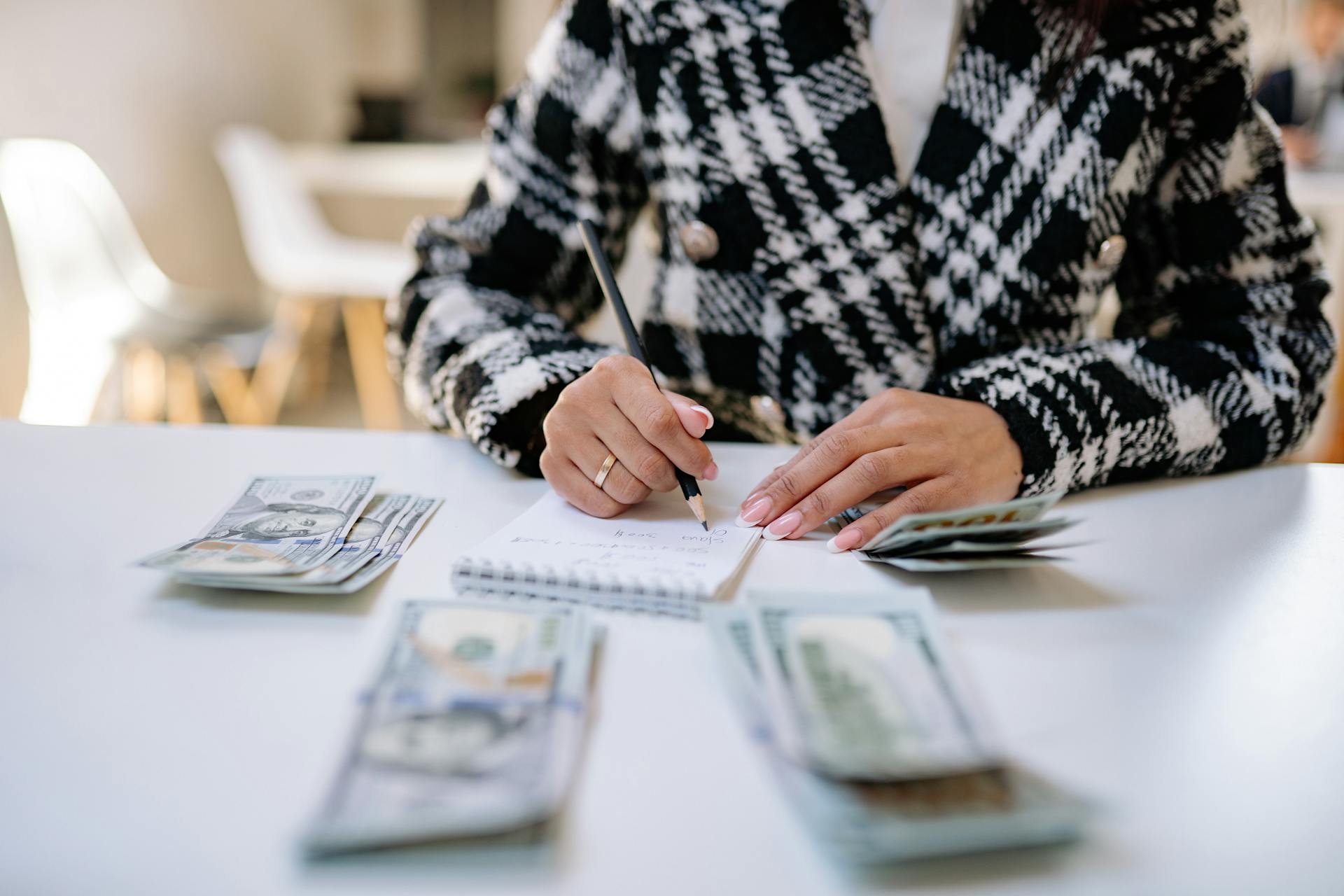 A woman making a note of her finances | Source: Pexels