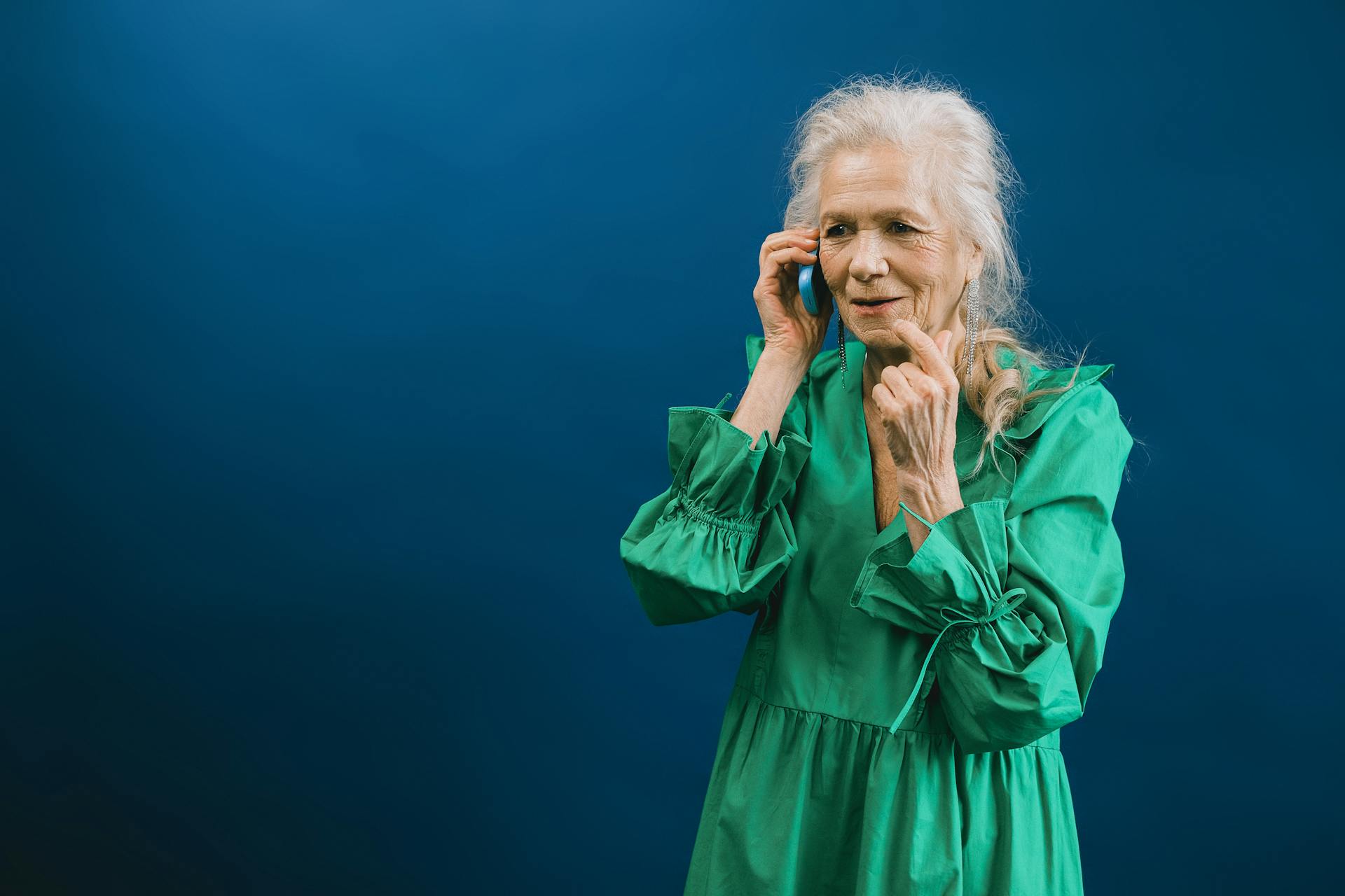 A delighted older woman talking on the phone | Source: Pexels