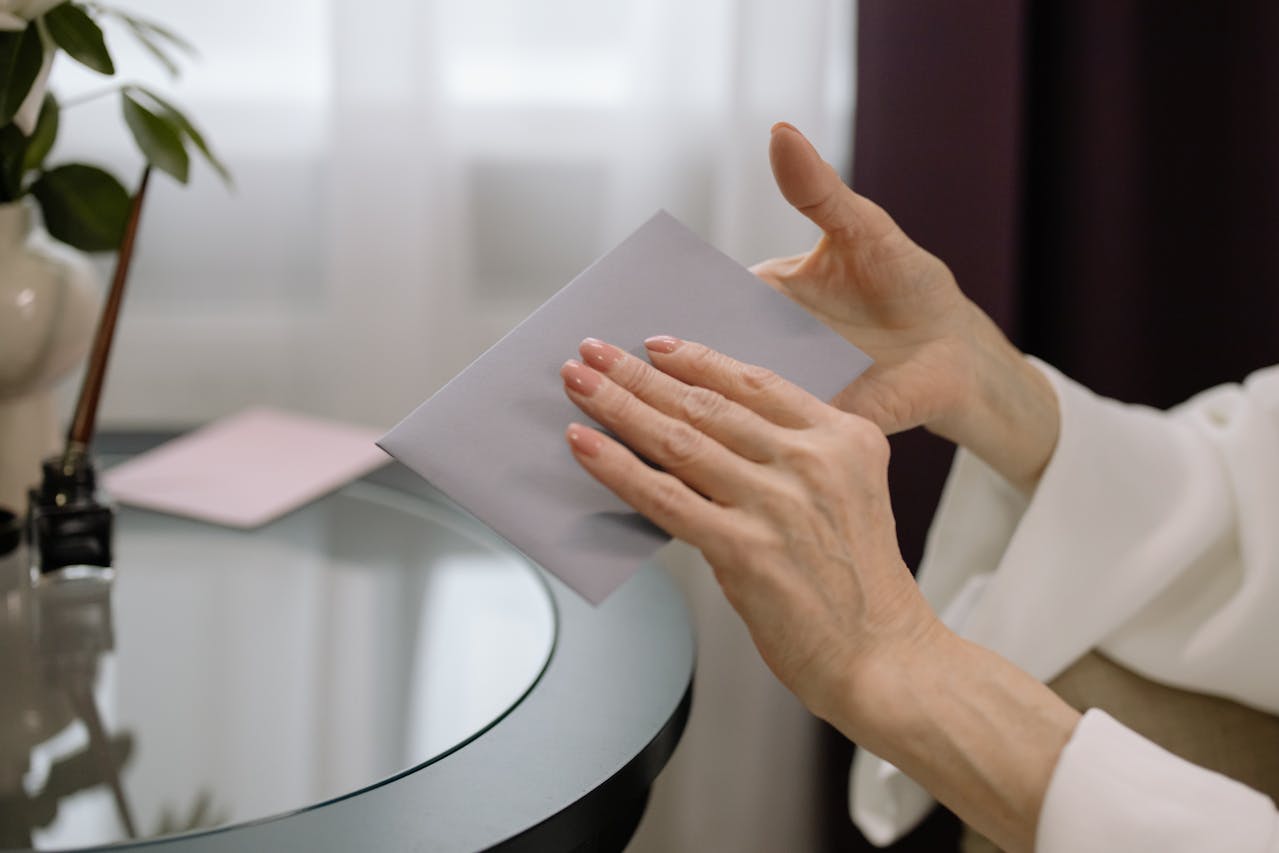 My Daughter Told Me Not to Visit Her Family Again — Days Later, She Was at My Door Begging 7 A woman holding an envelope | Source: Pexels