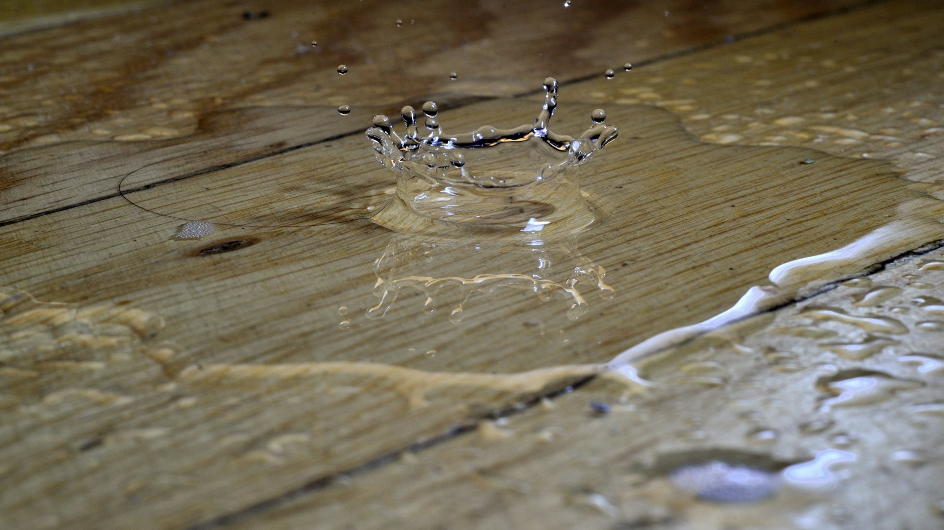 A puddle of water on a wooden floor | Source: Unsplash