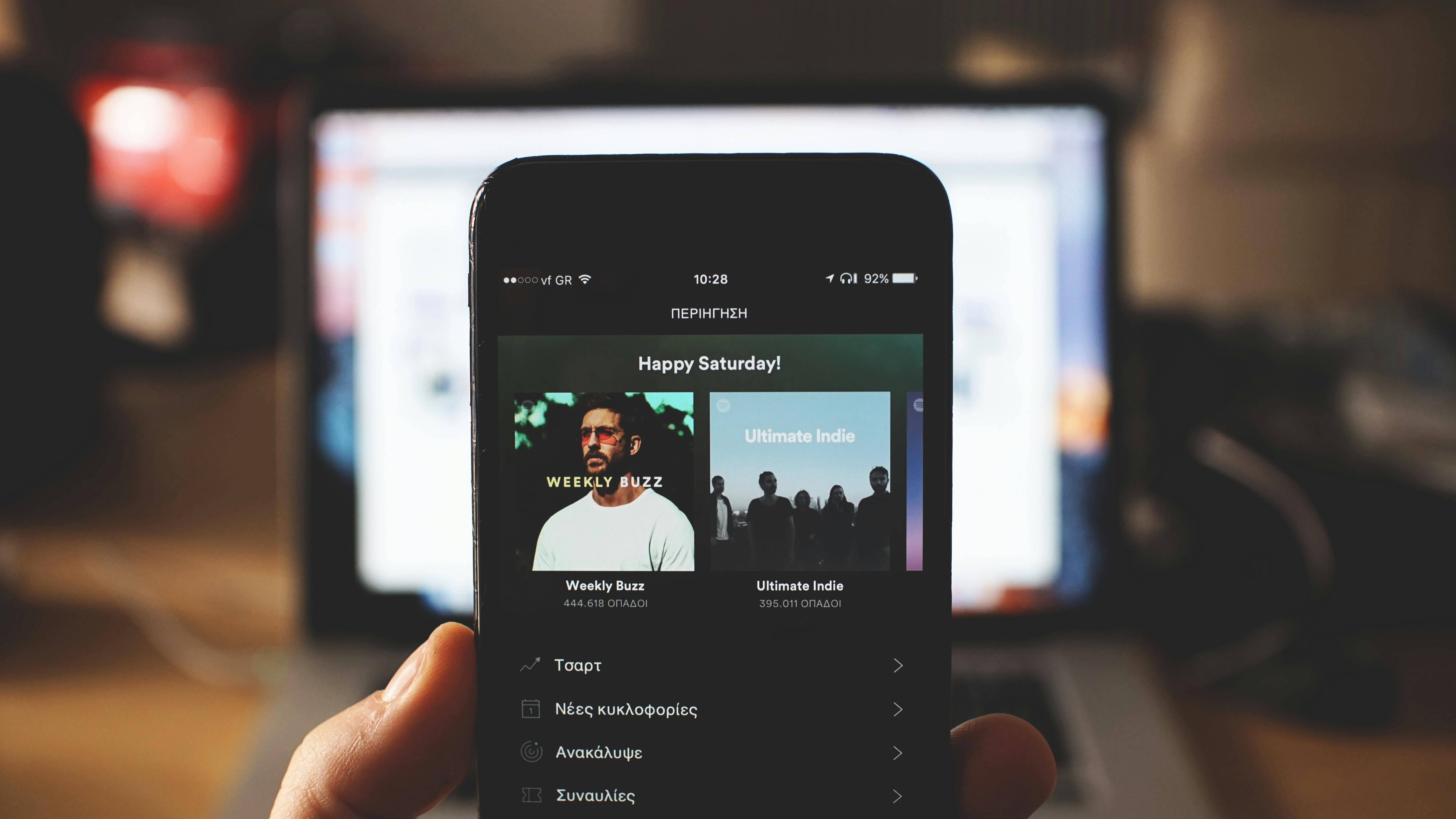A person holding a phone open to Spotify | Source: Pexels