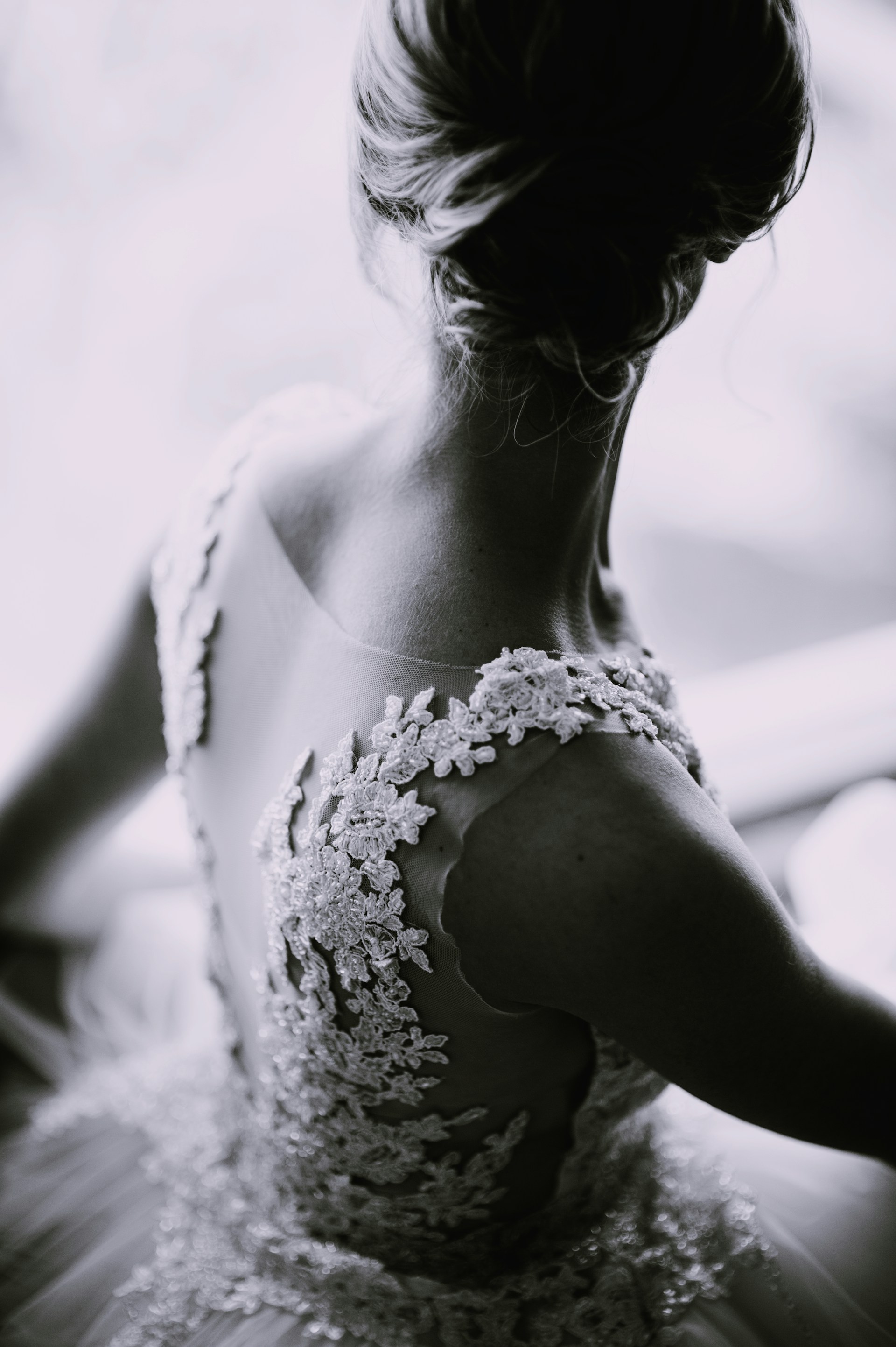 A woman wearing a wedding gown glancing over one shoulder | Source: Unsplash
