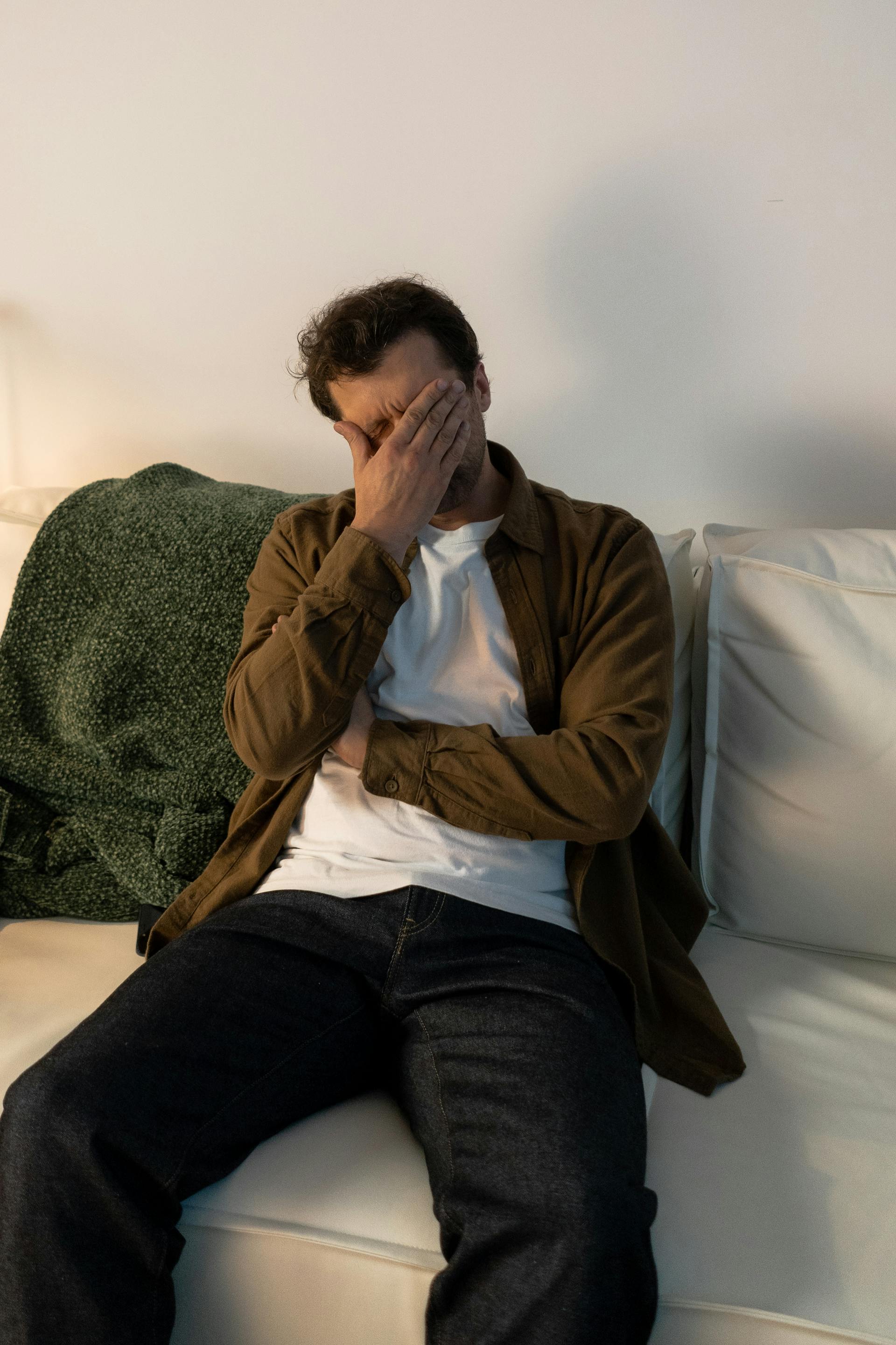 A man covering his face with his hand | Source: Pexels