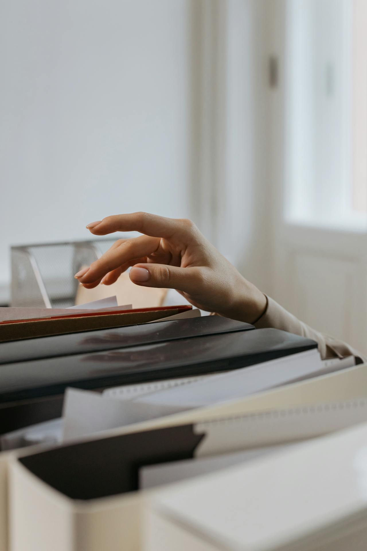 A woman reaching out for a file | Source: Pexels