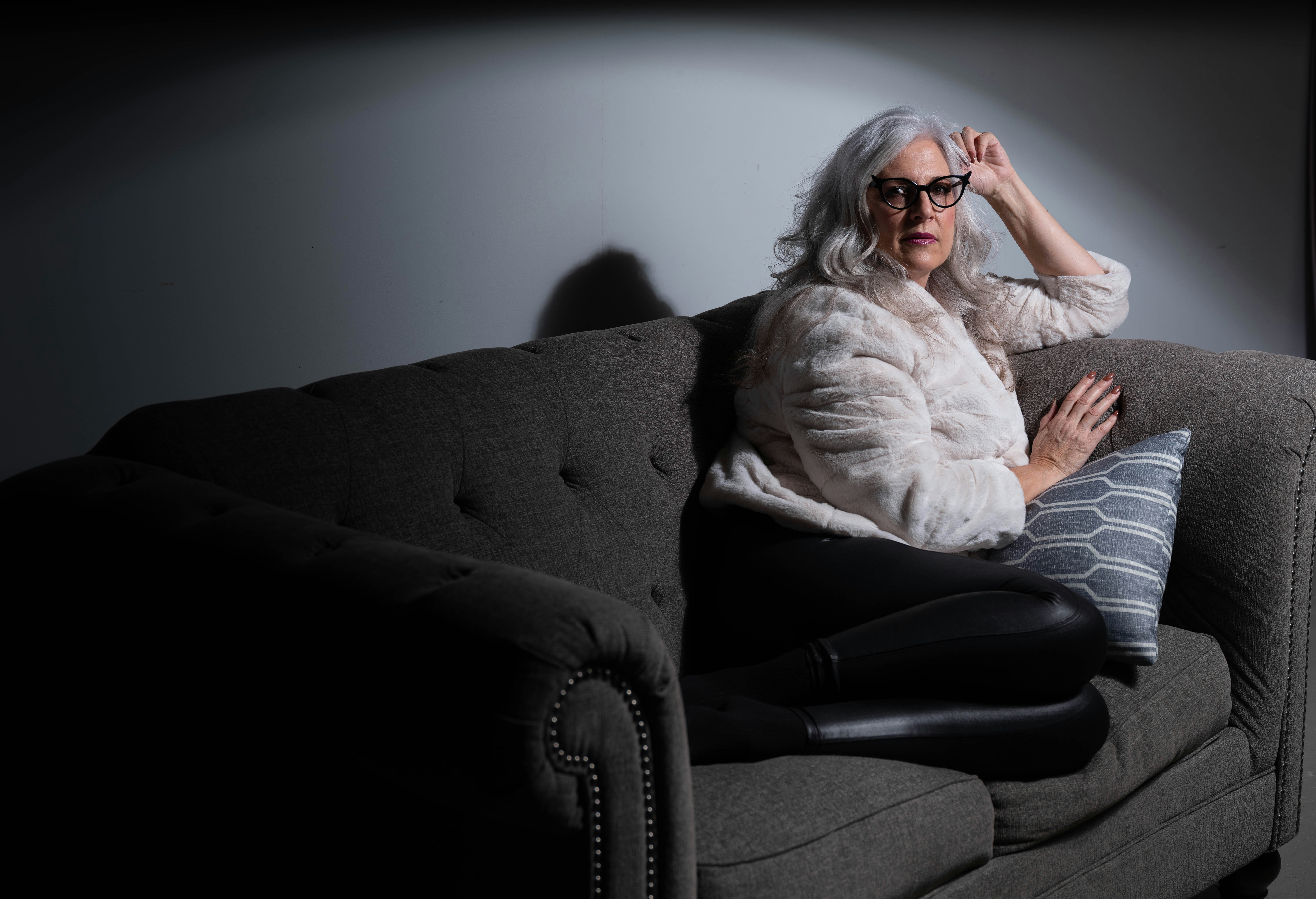 An older woman sitting on a couch | Source: Unsplash