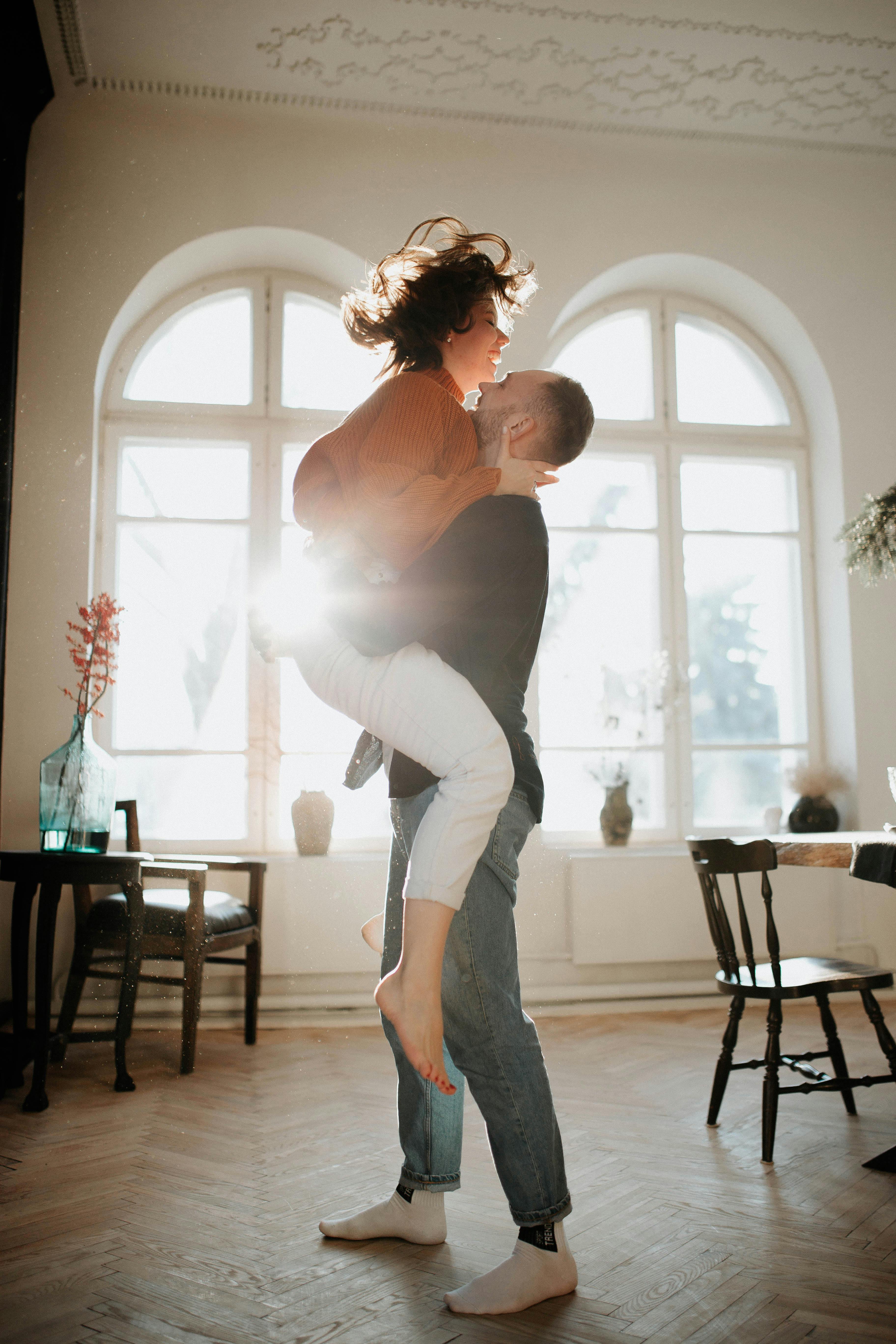 A woman jumping into a man's arms | Source: Pexels