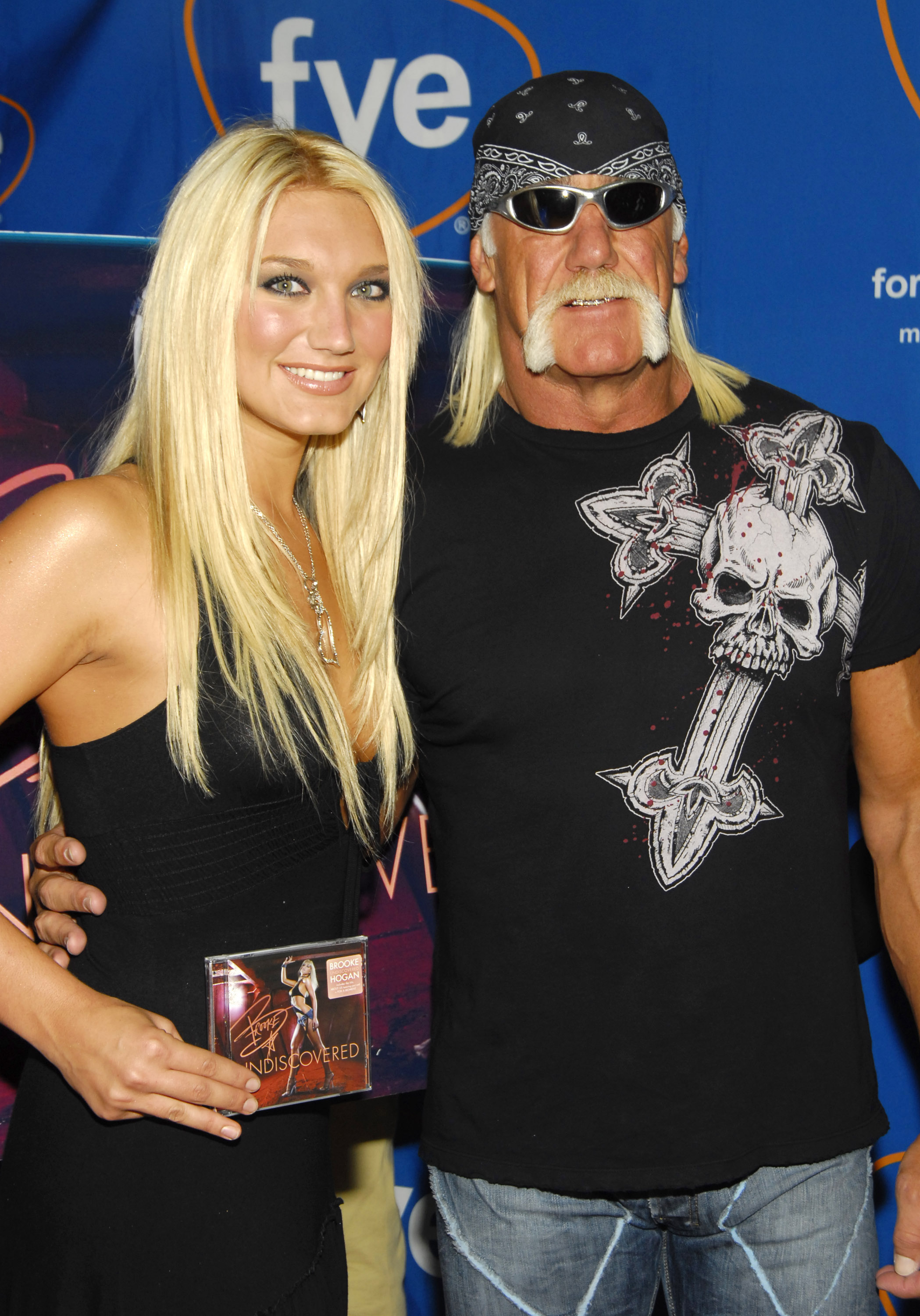 Brooke Hogan and Hulk Hogan pose for a photo at Brooke Hogan Signs Her New CD "Undiscovered" at FYE on October 26, 2004, in New York City. | Source: Getty Images