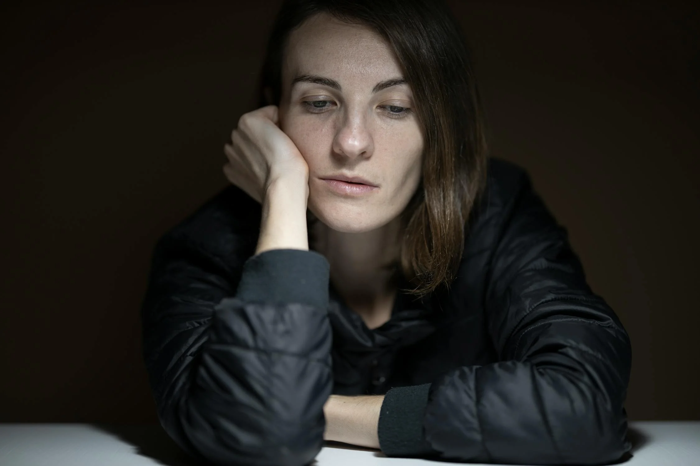 A sad woman sitting at a table | Source: Pexels