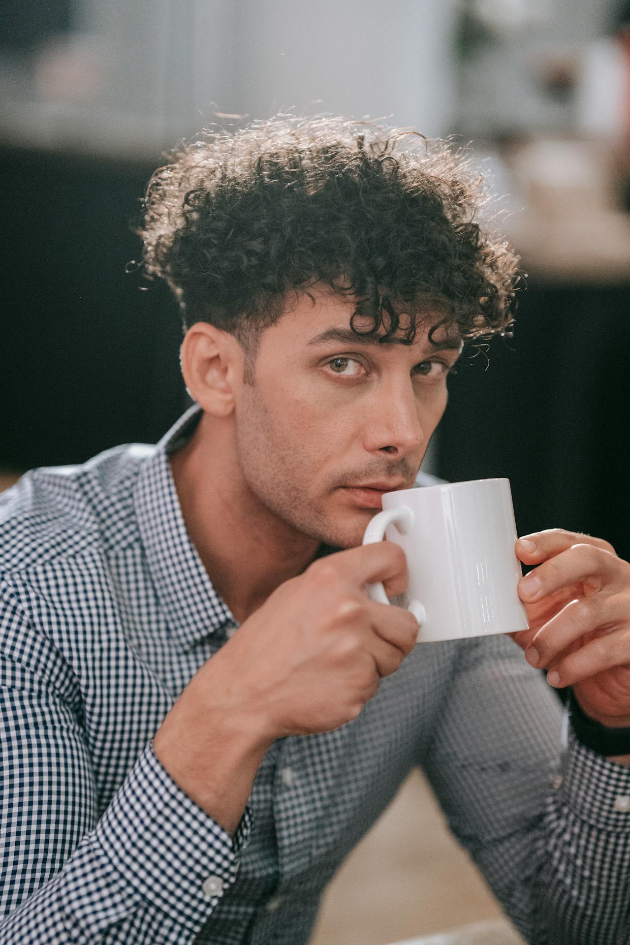A man holding a white ceramic cup | Source: Pexels