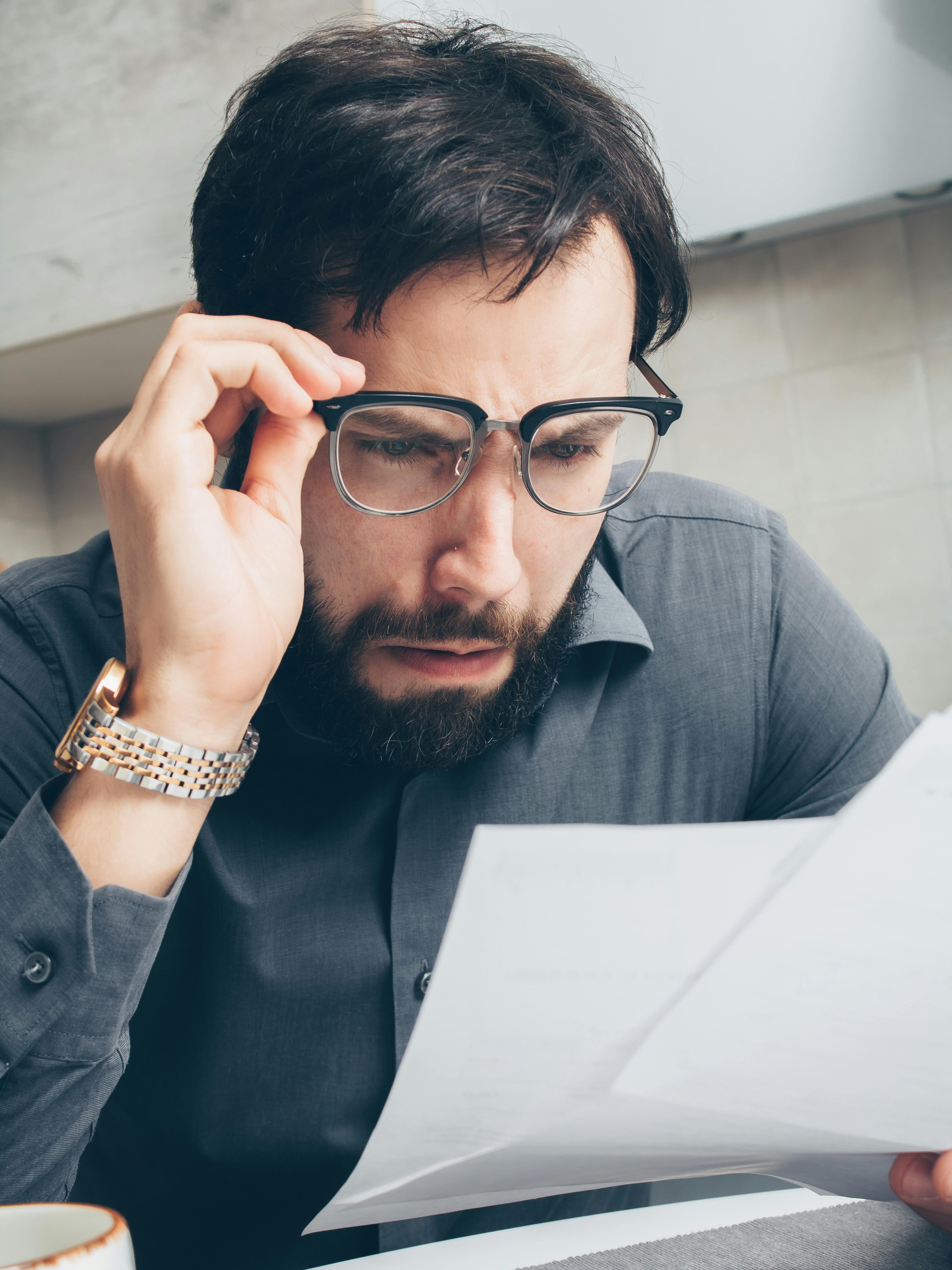 Shocked man staring at a document | Source: Pexels