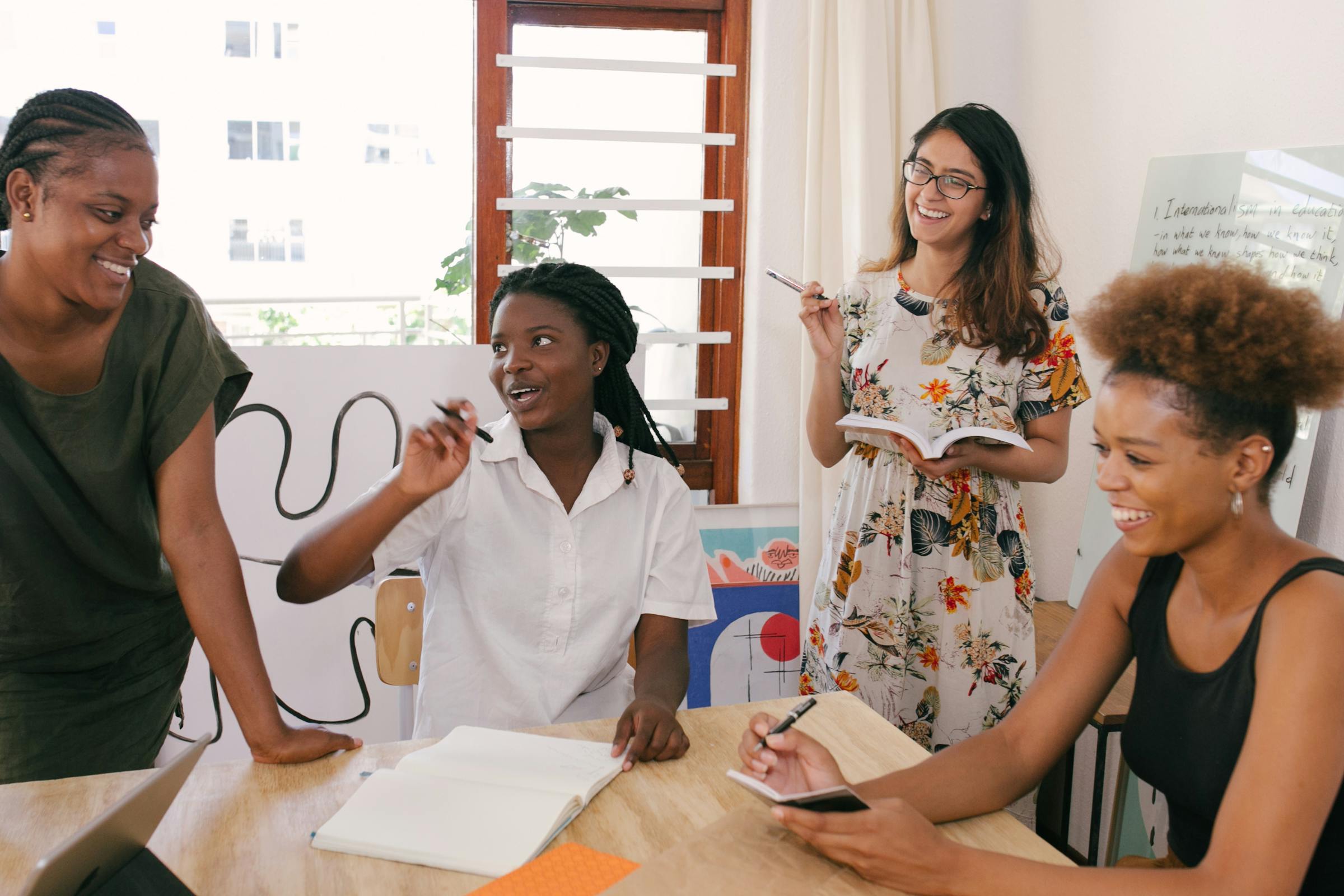 People smiling happily in an office conference room | Source: Pexels