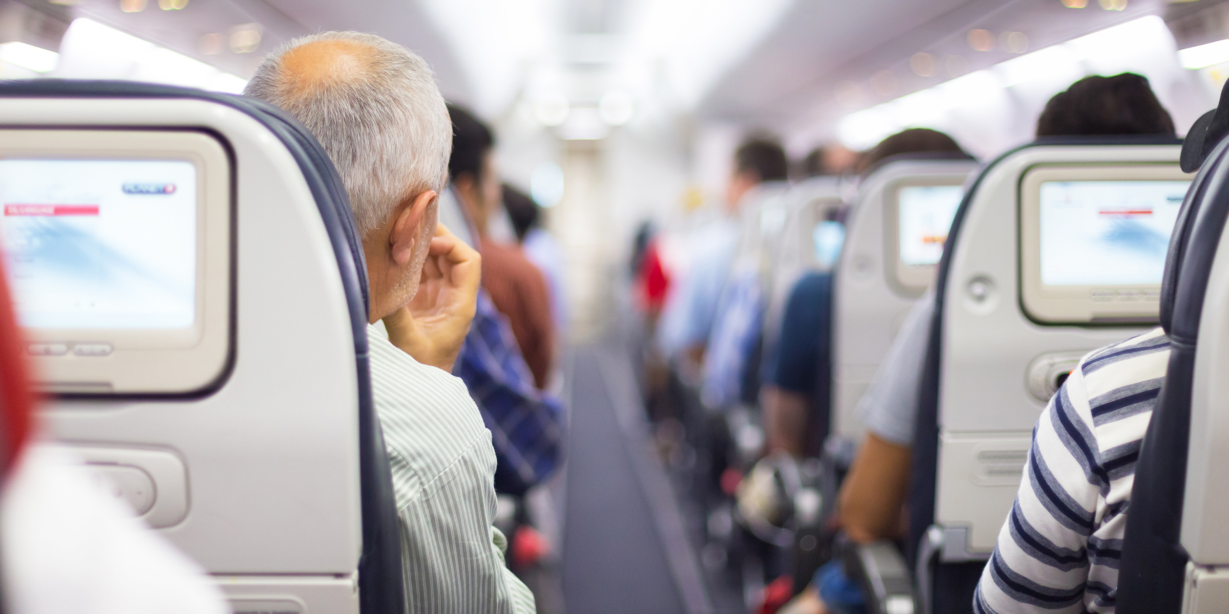 Passengers seated on a plane | Source: Shutterstock