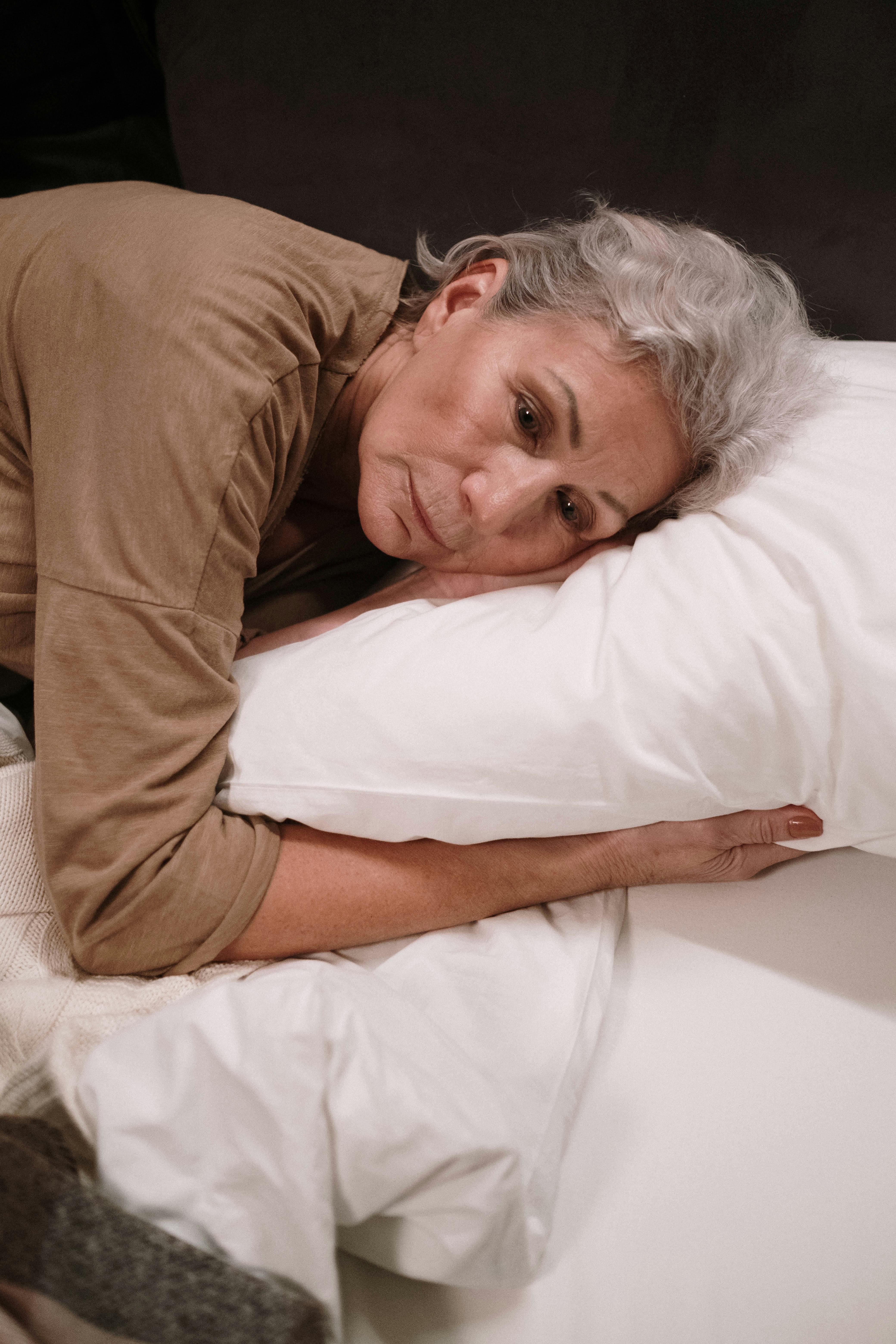 A sad woman lying in bed | Source: Pexels