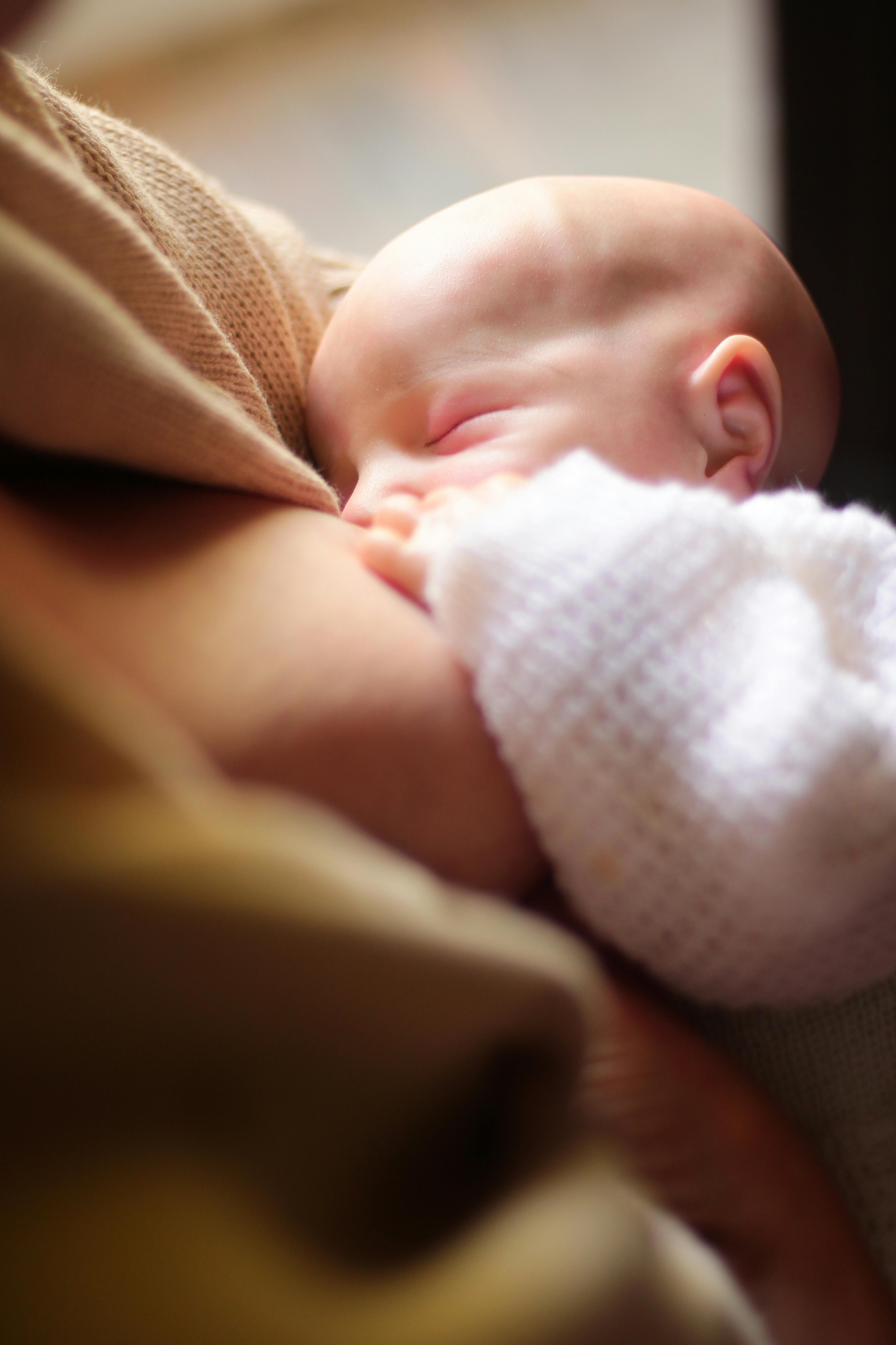 A woman feeding a baby girl | Source: Pexels