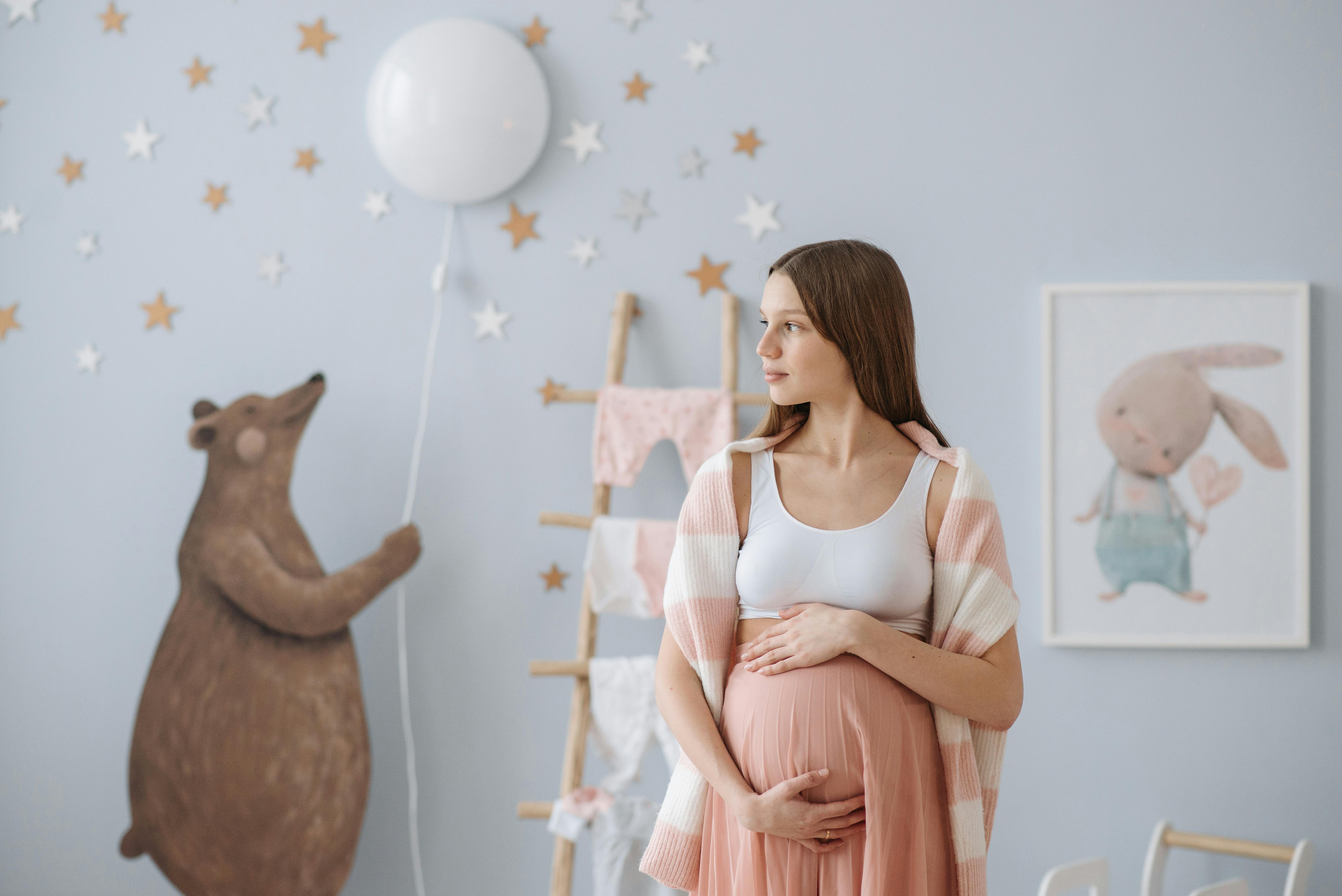 A pregnant woman standing in a nursery | Source: Pexels