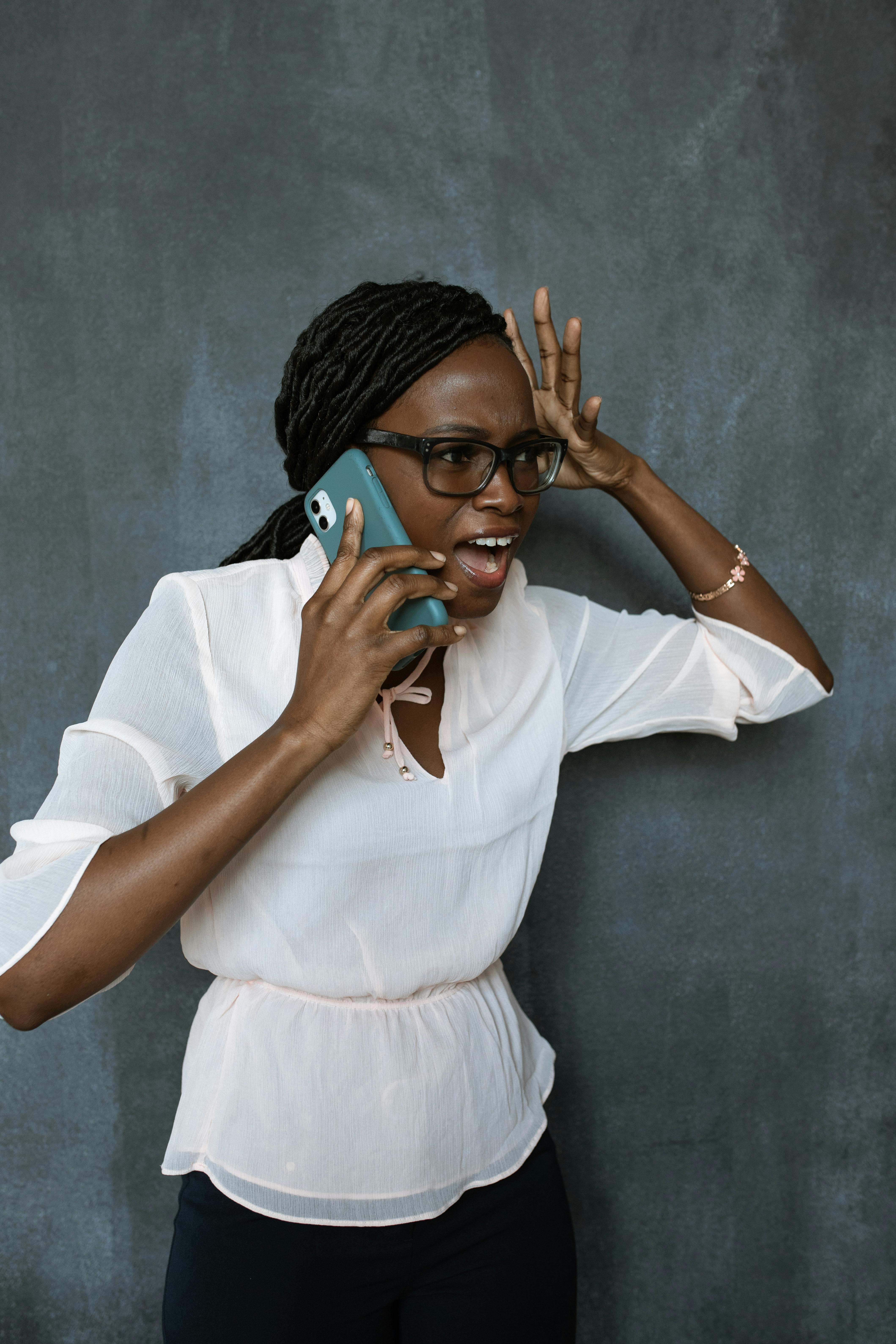 A shocked woman on a call | Source: Pexels