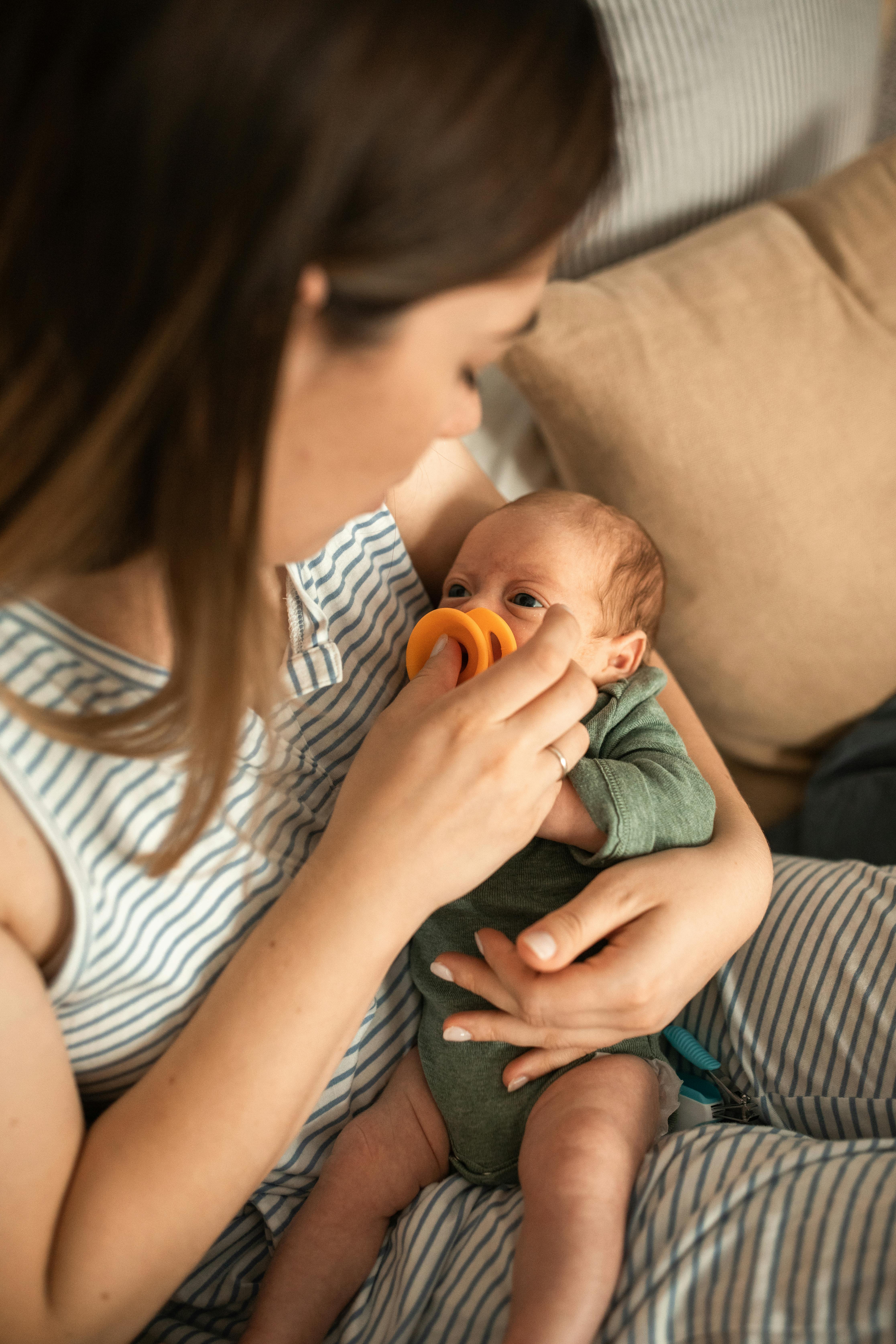 A mom carrying a baby | Source: Pexels