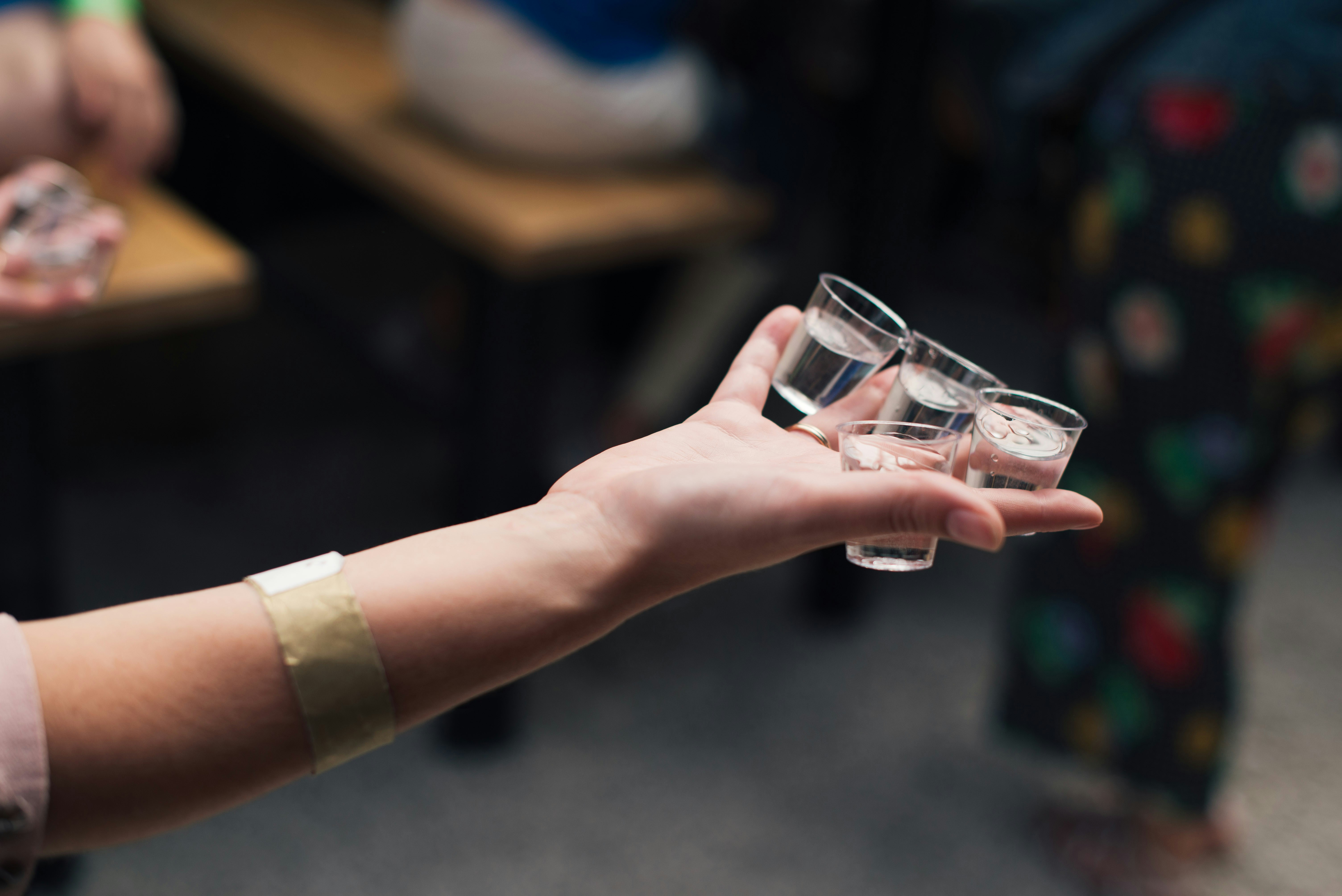 A person holding shot glasses | Source: Unsplash