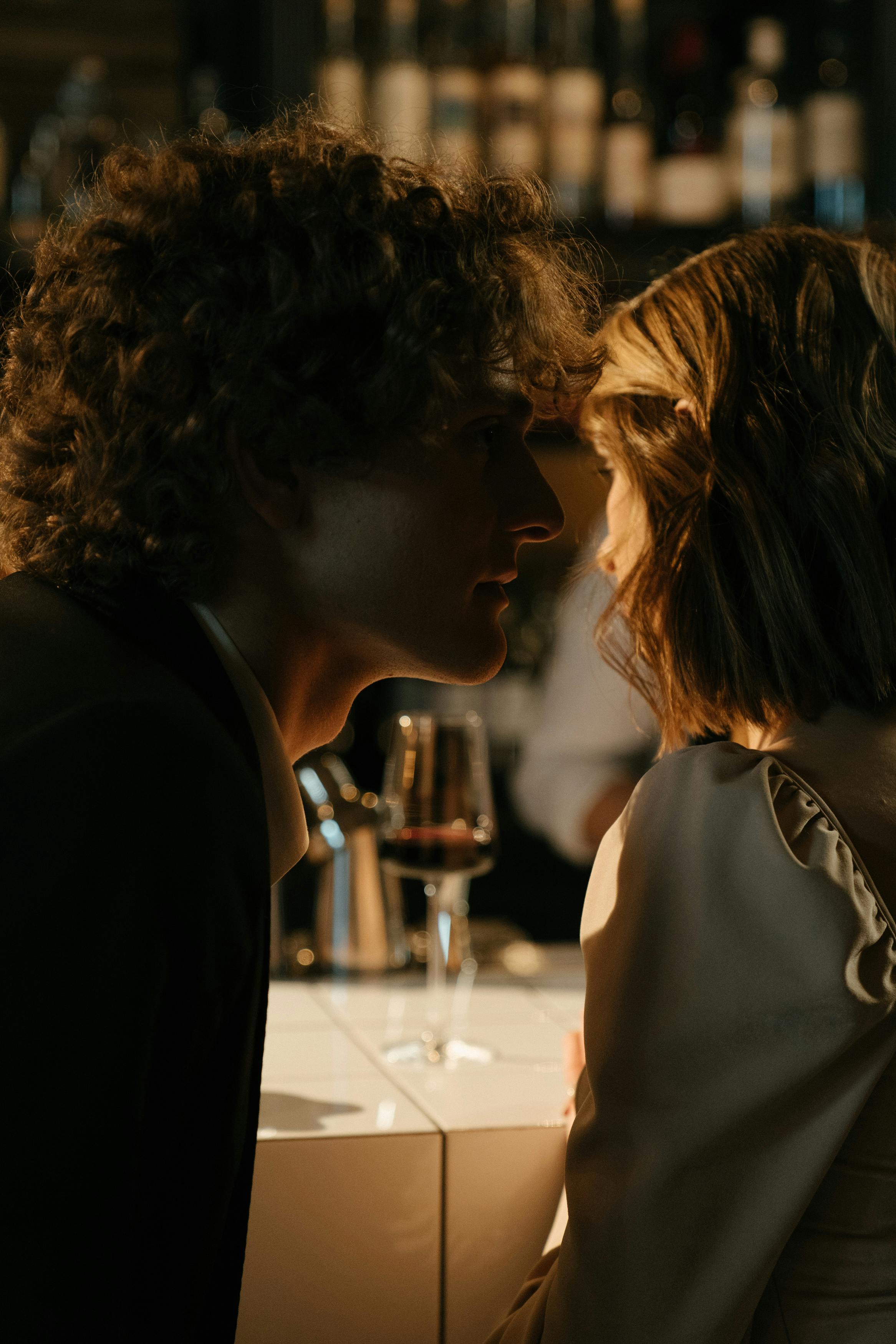 A man whispering in a woman's ear | Source: Pexels