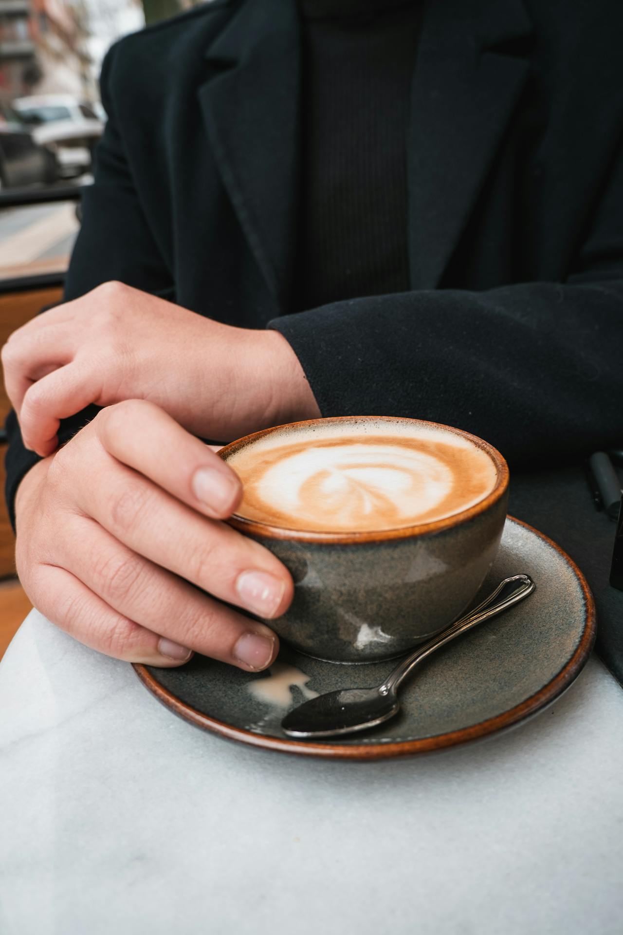 A man holding a cup of coffee | Source: Pexels