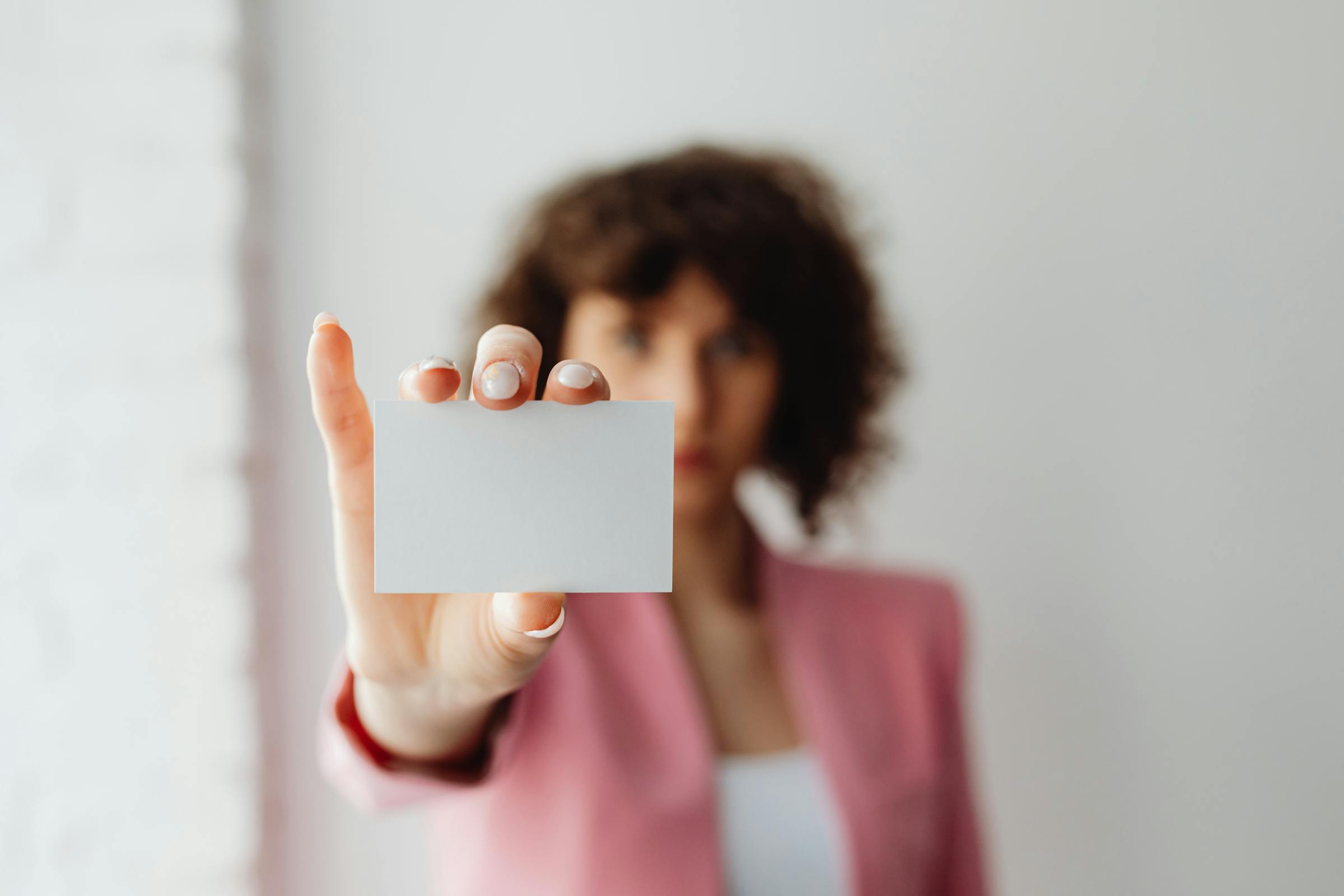 A woman holding up a card | Source: Pexels