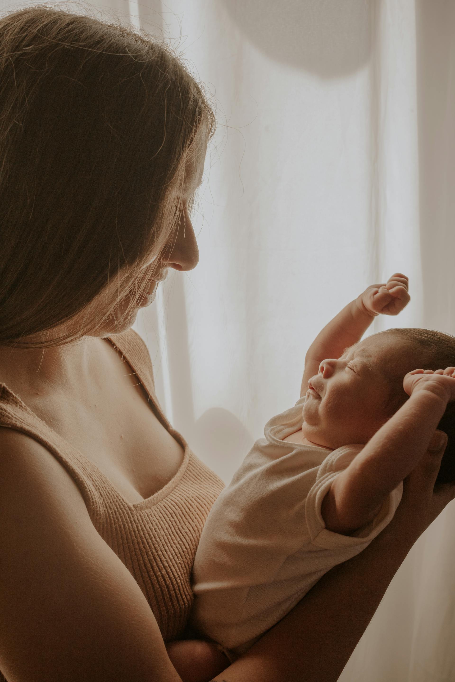 A woman holding a baby | Source: Pexels