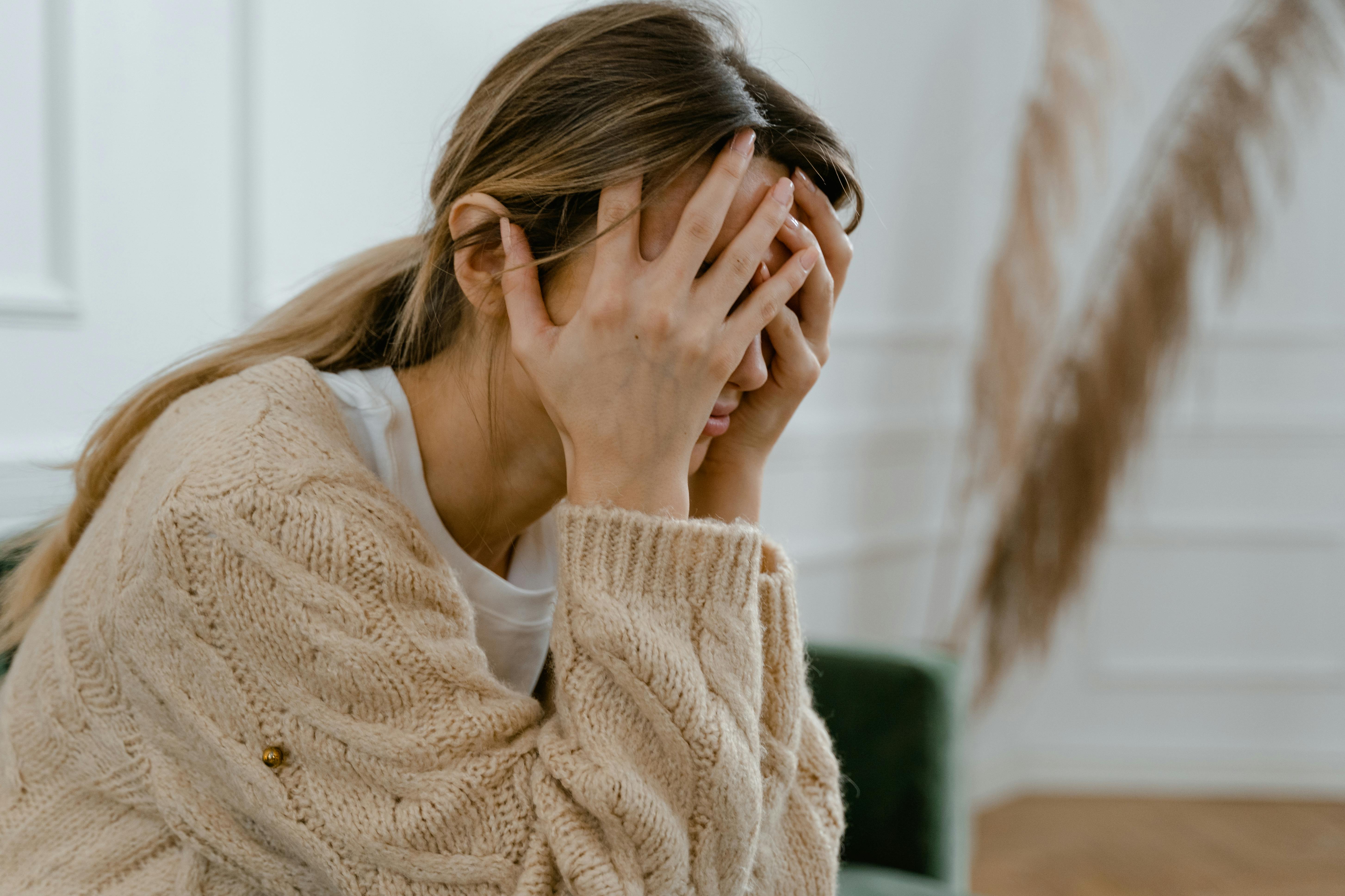 A woman with her face in her hands | Source: Pexels