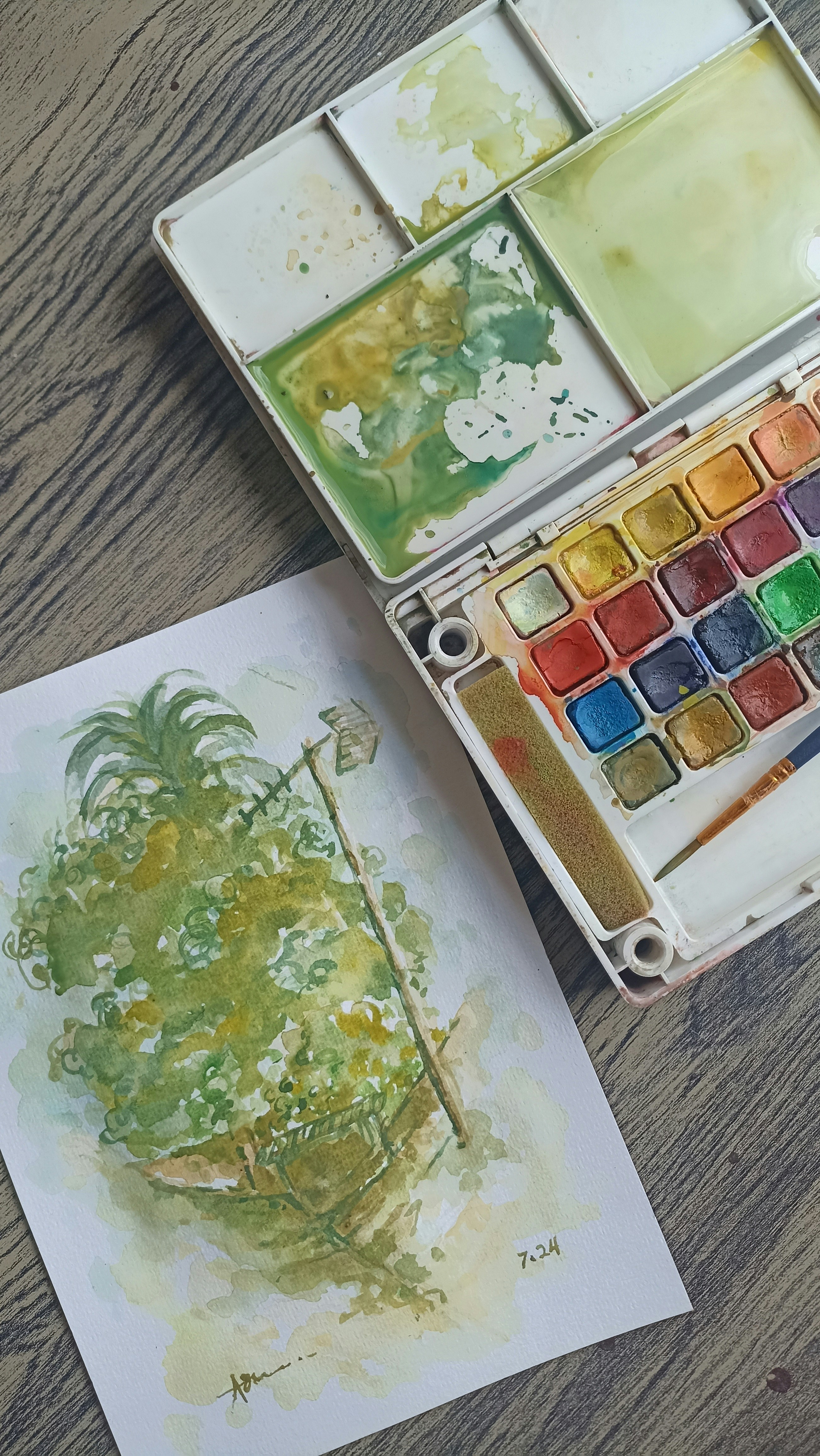 A watercolor paint set and artwork | Source: Unsplash