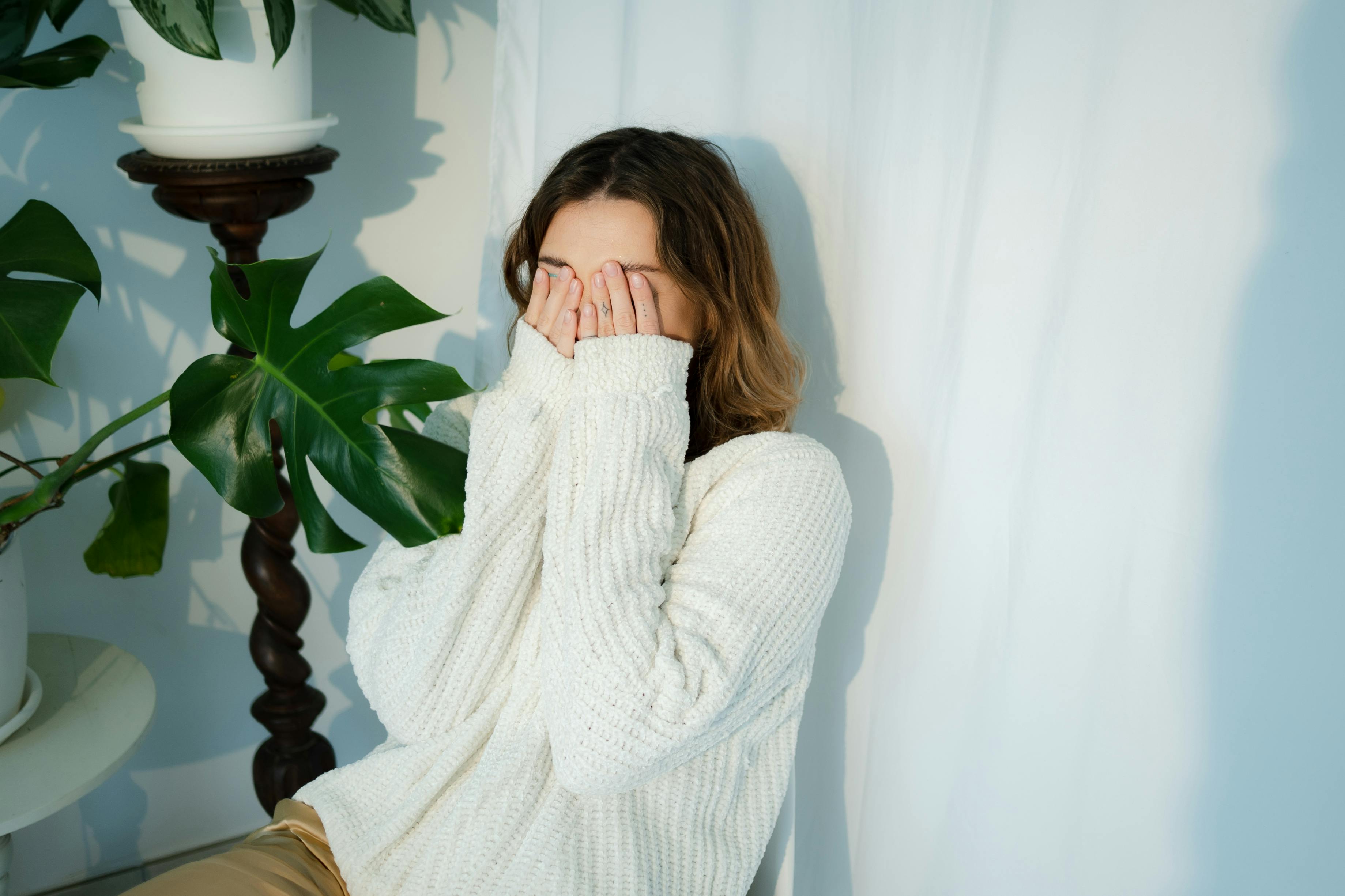An embarrassed woman covering her face | Source: Pexels