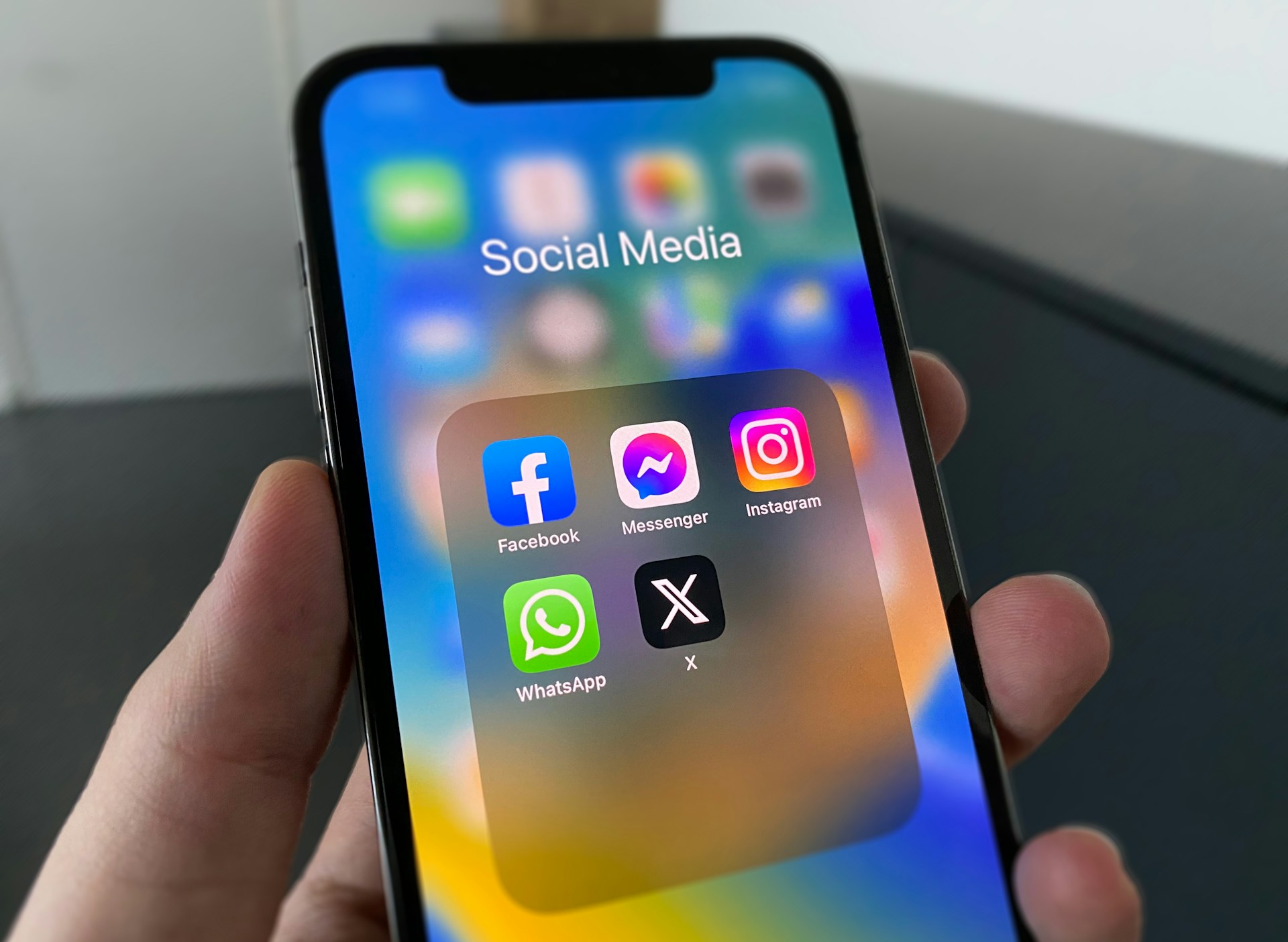 A person holding their phone revealing social media apps on the screen | Source: Unsplash