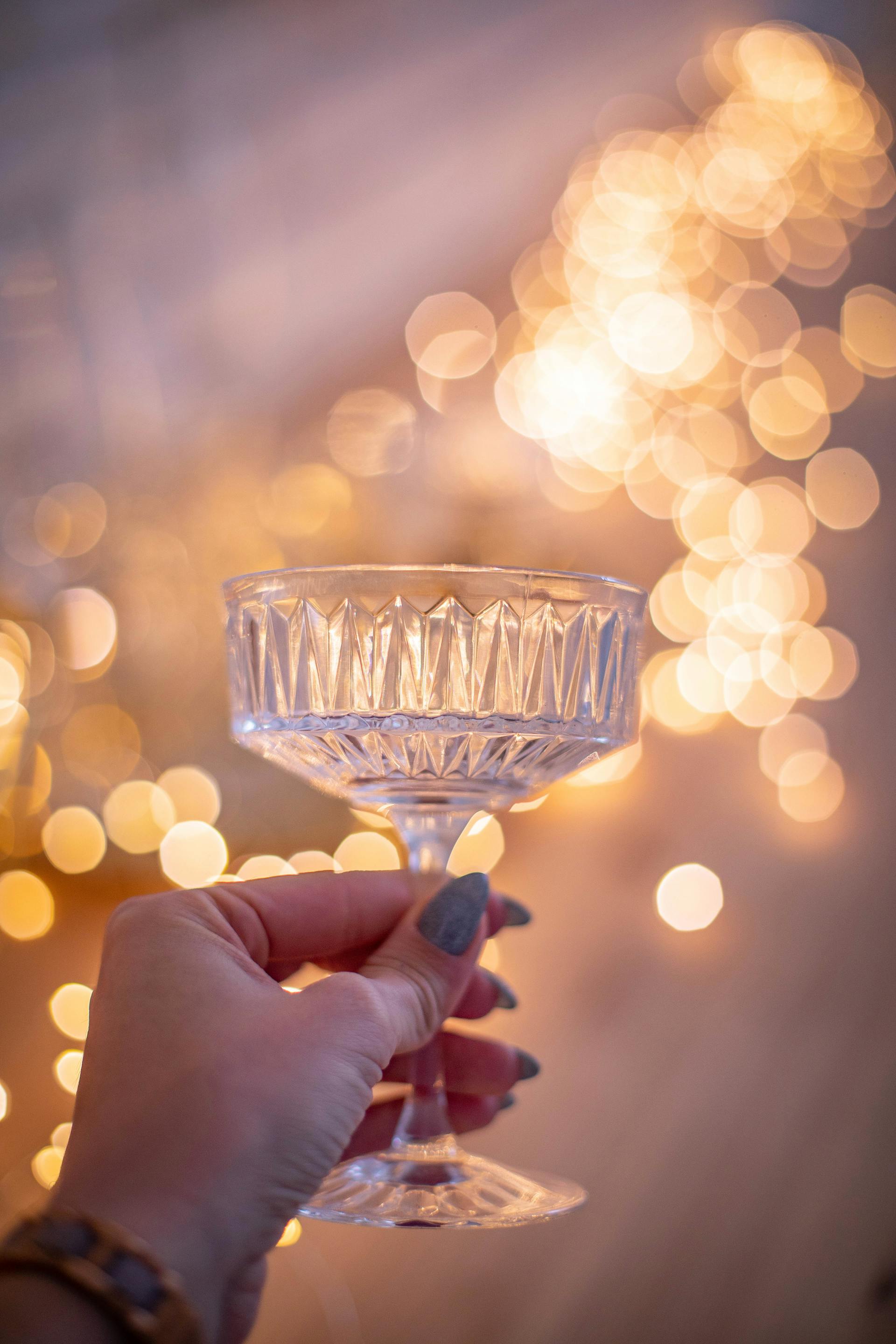 A woman holding up a glass | Source: Pexels