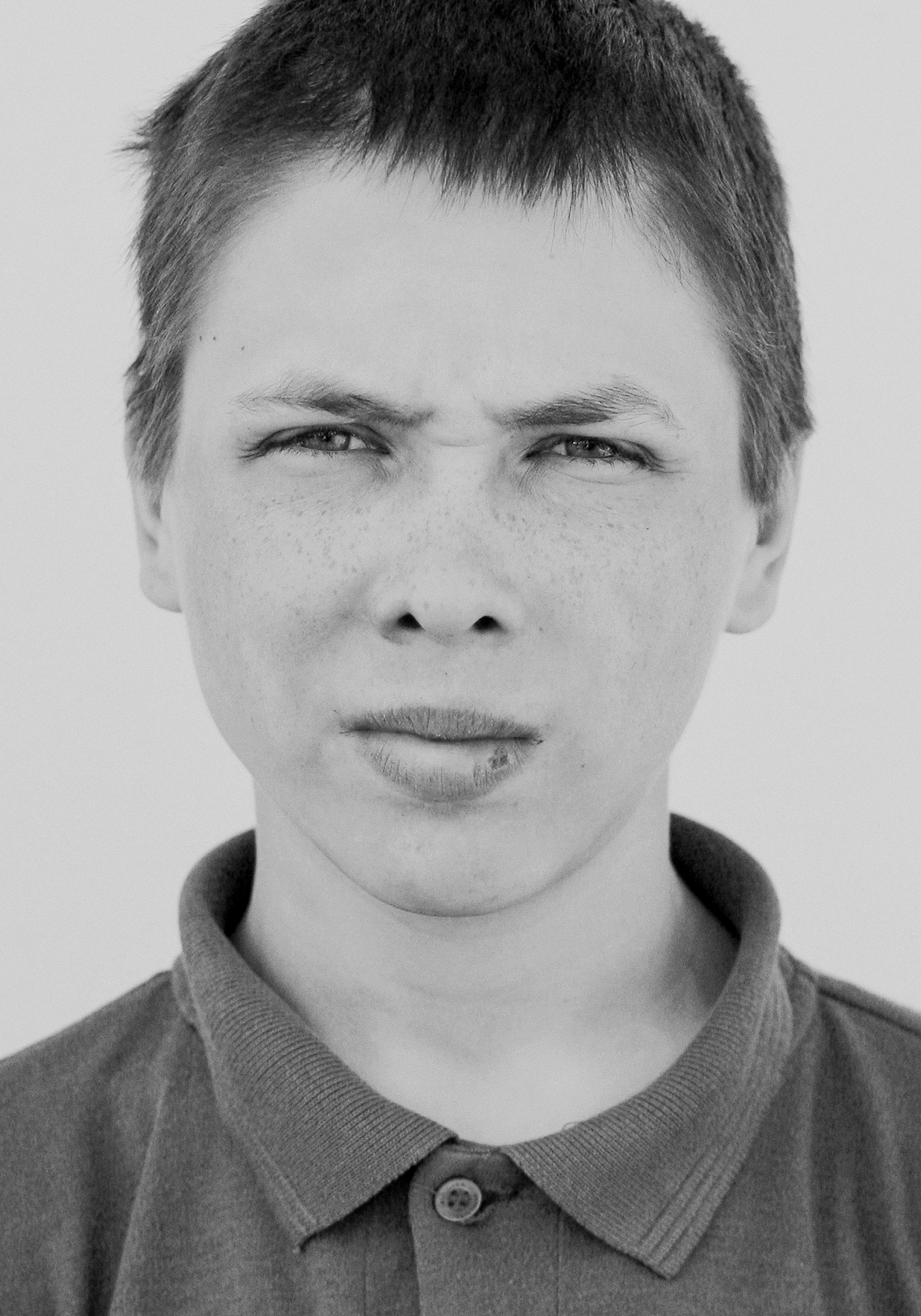 A boy pulling a face at someone | Source: Unsplash