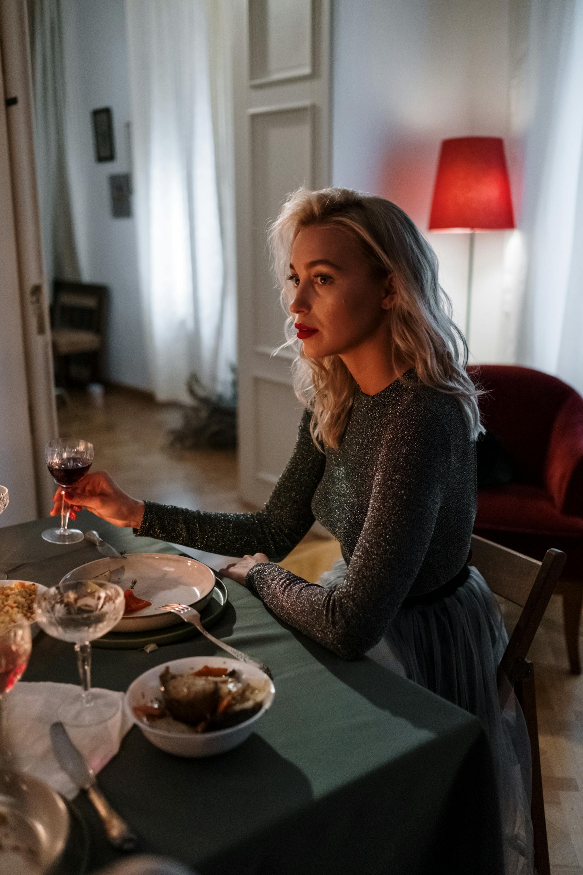 A serious woman at a dinner table | Source: Pexels