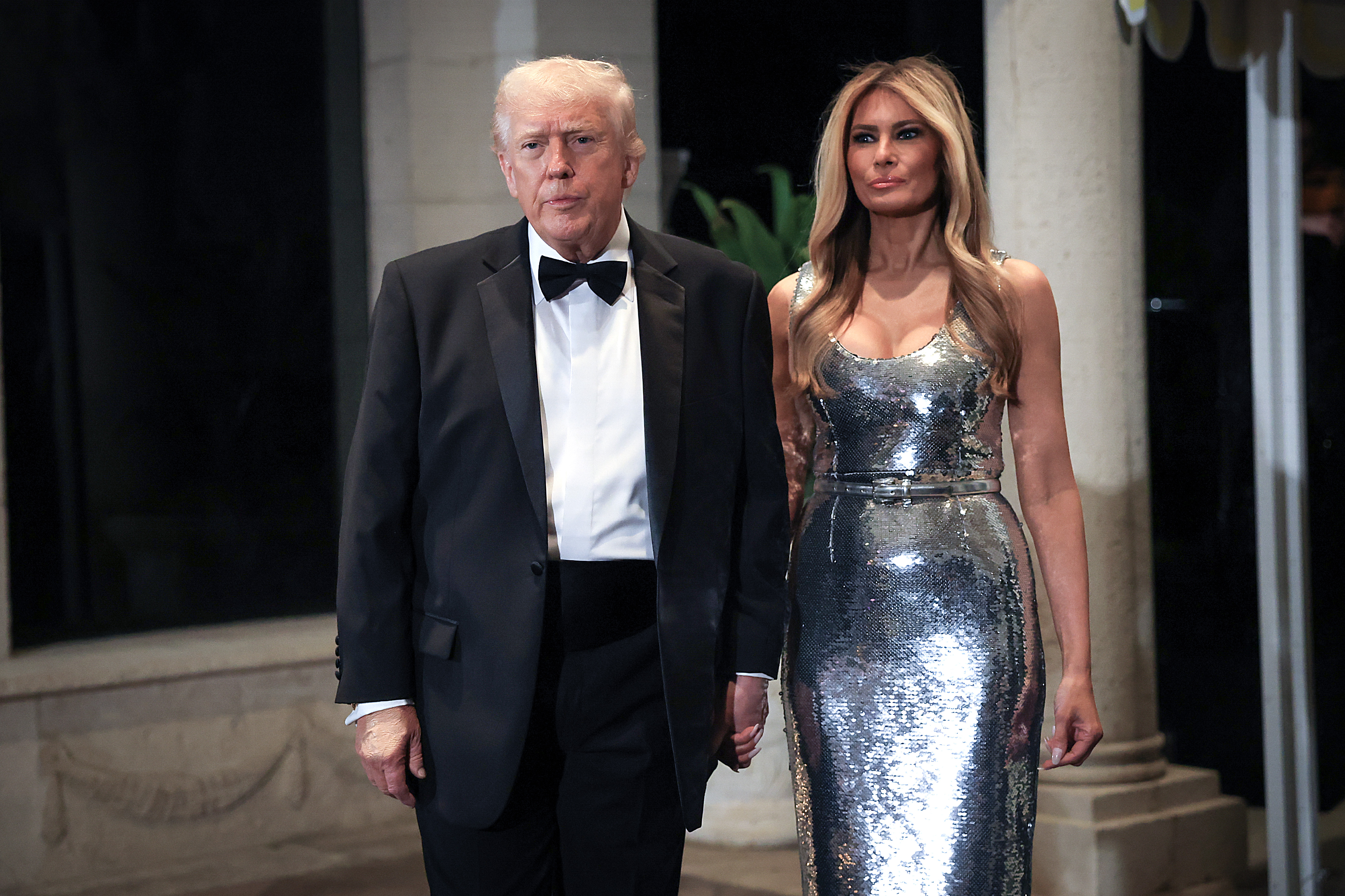 U.S. President Donald Trump and first lady Melania Trump arrive for a New Year’s Eve event at his Mar-a-Lago home on December 31, 2025 in Palm Beach, Florida. | Source: Getty Images