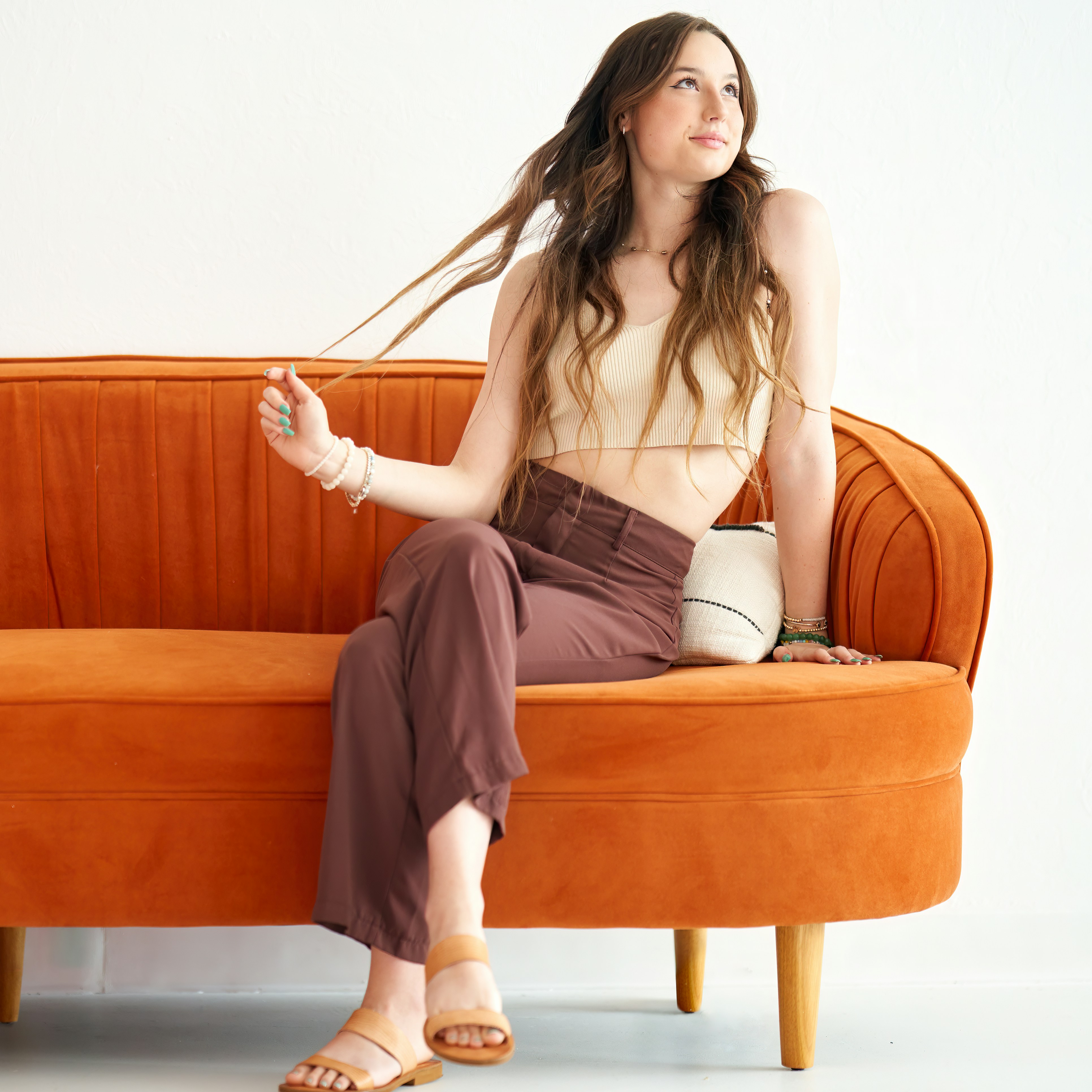 A young woman sitting on a couch | Source: Unsplash