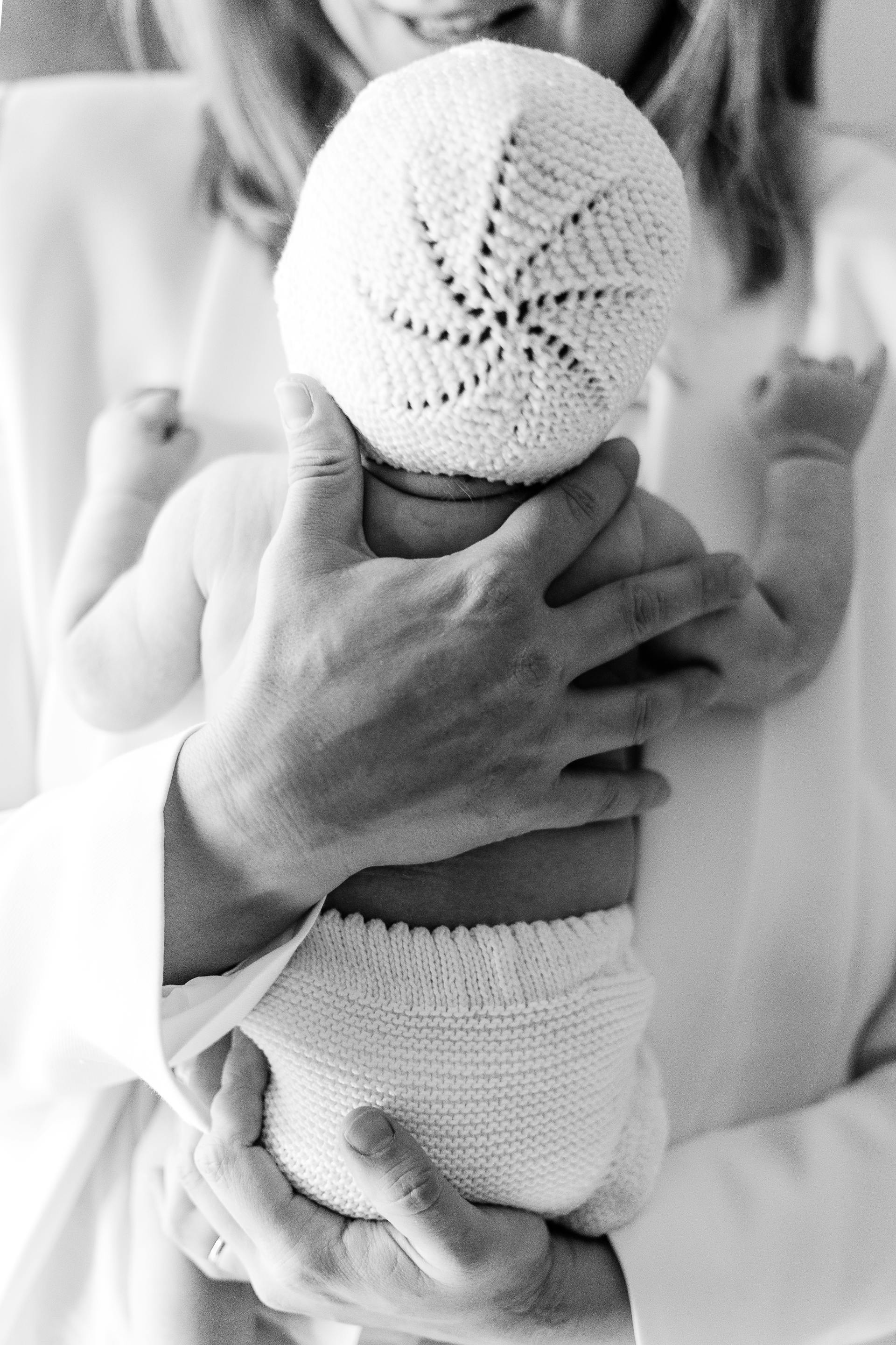 Grayscale photo of a woman holding a newborn baby | Source: Pexels