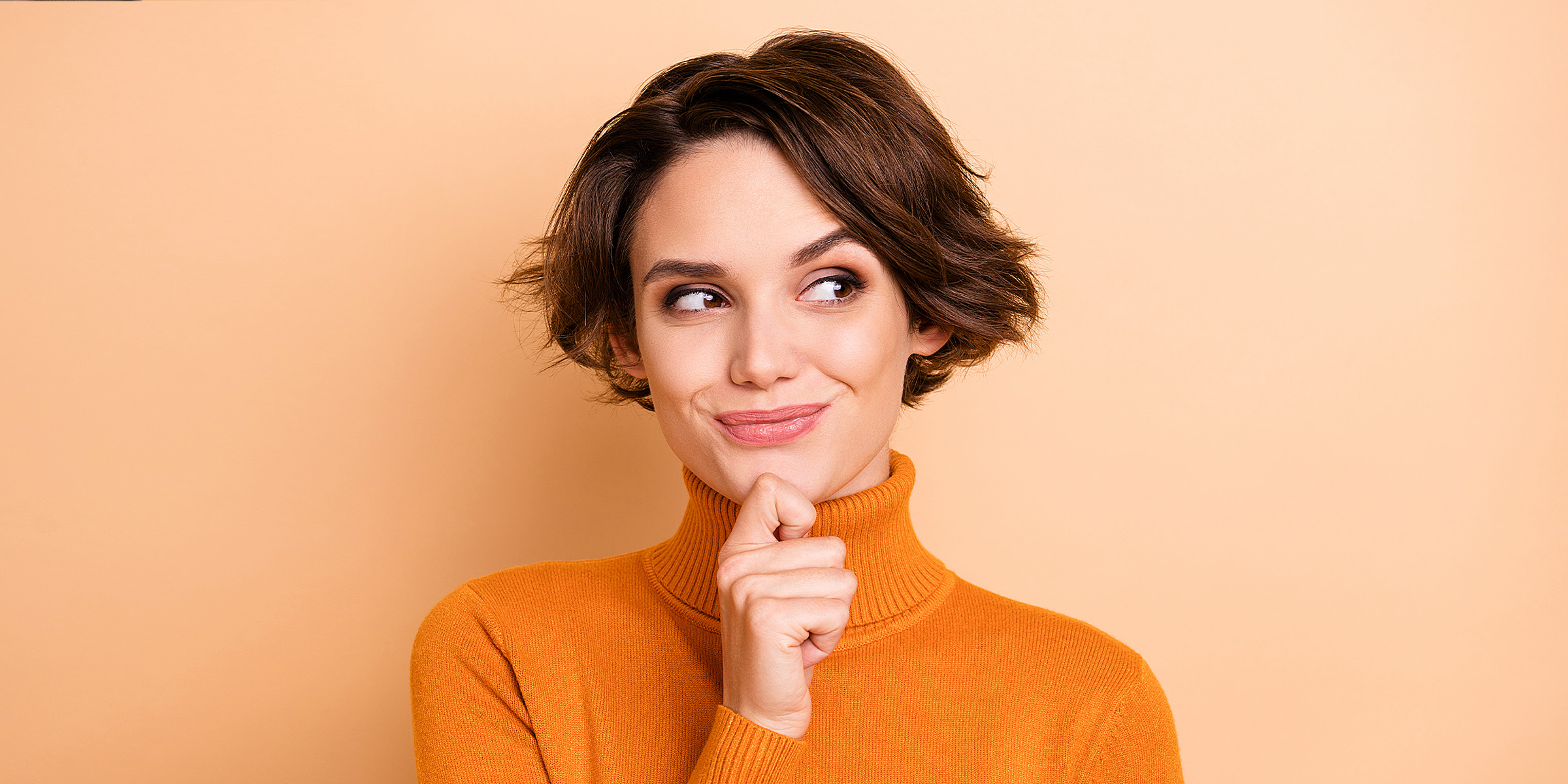 A woman smiling in a cunning way | Source: Shutterstock