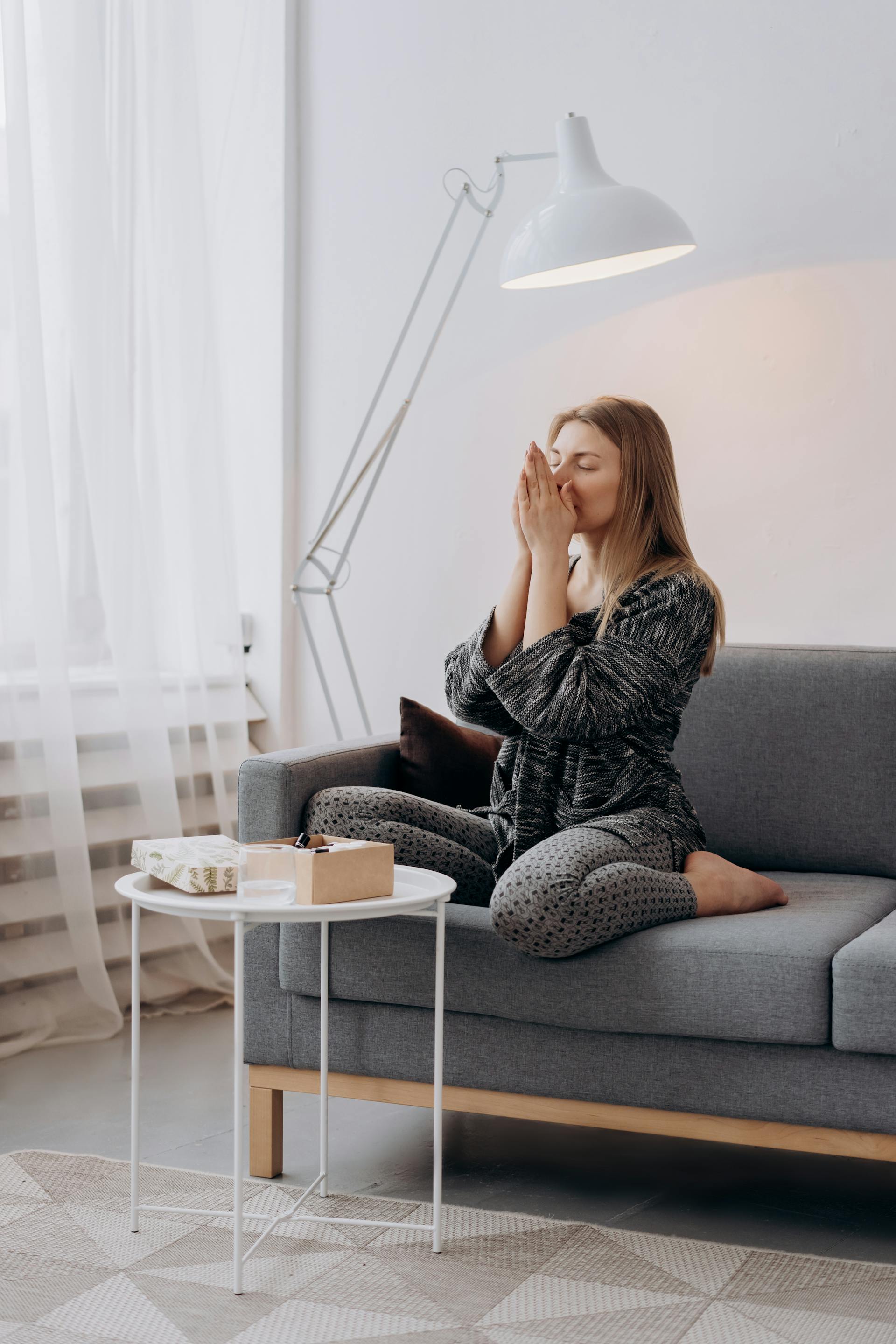 A tired woman sitting on the sofa | Source: Pexels