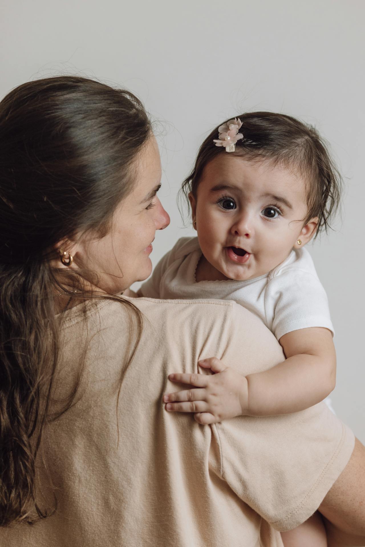 A mother holding her baby daughter | Source: Pexels