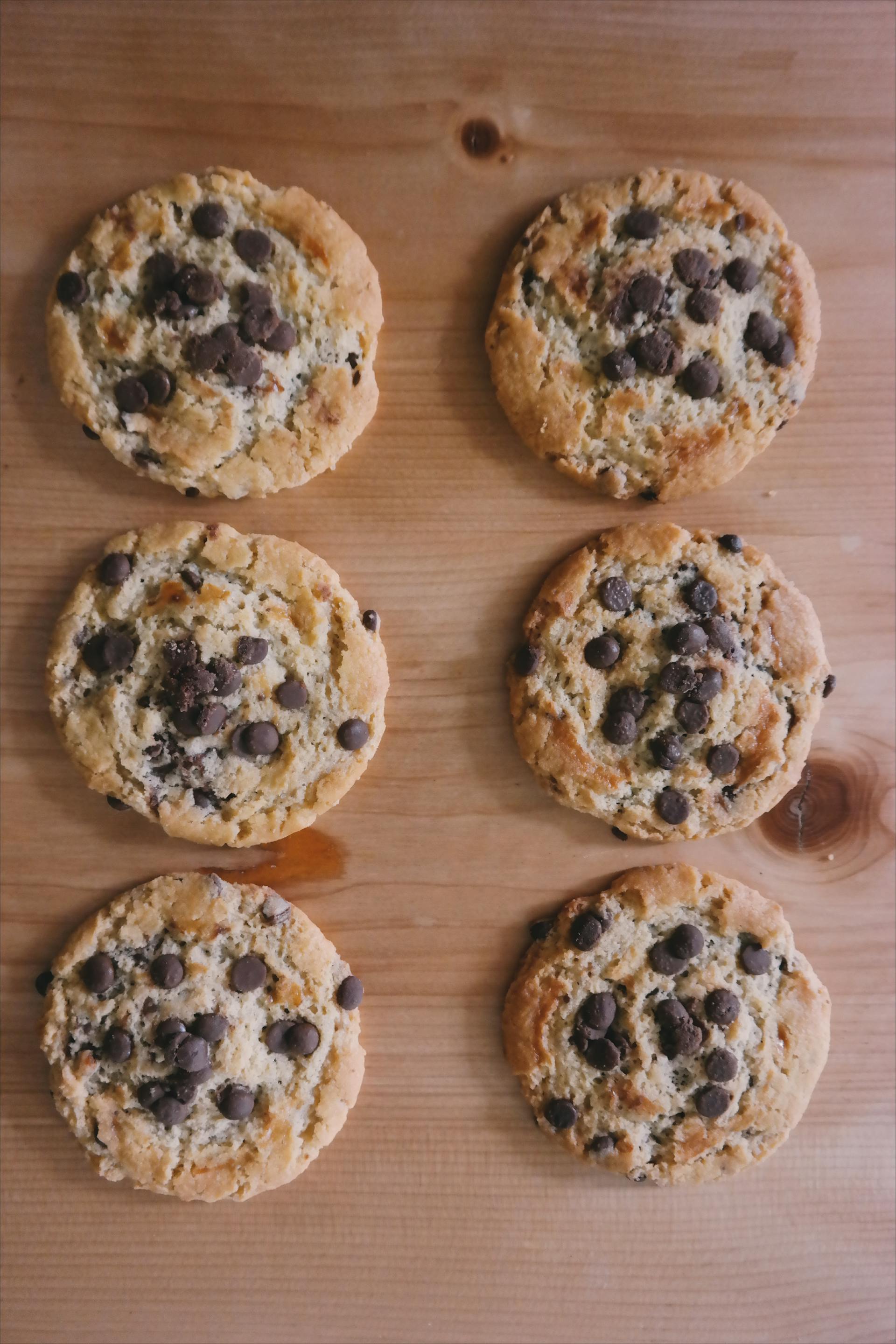 A collection of chocolate chip cookies on a brown surface | Source: Pexels