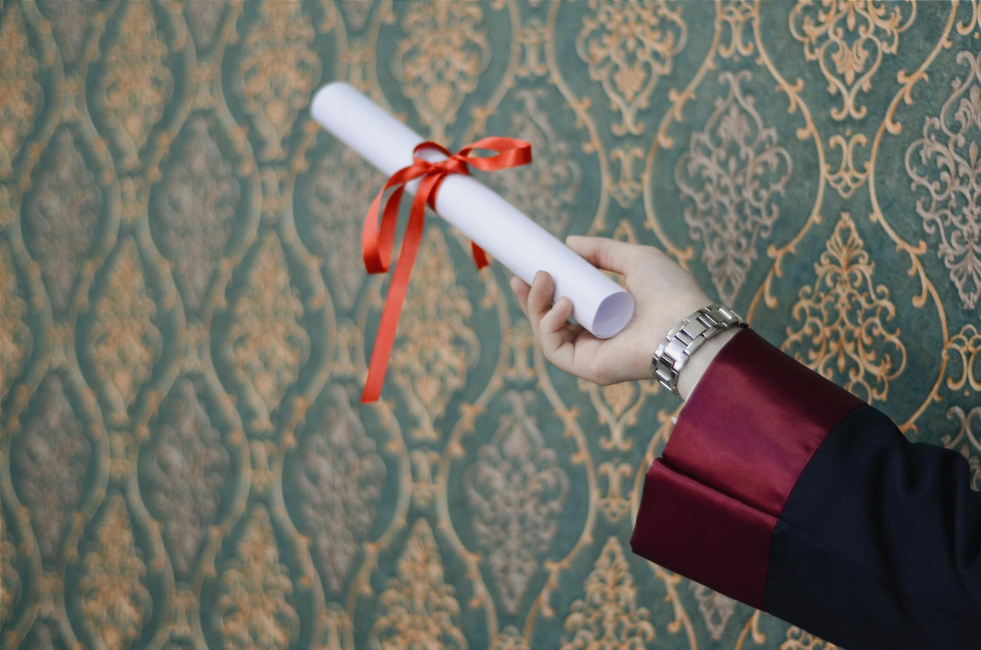 A person holding a white scroll | Source: Pexels