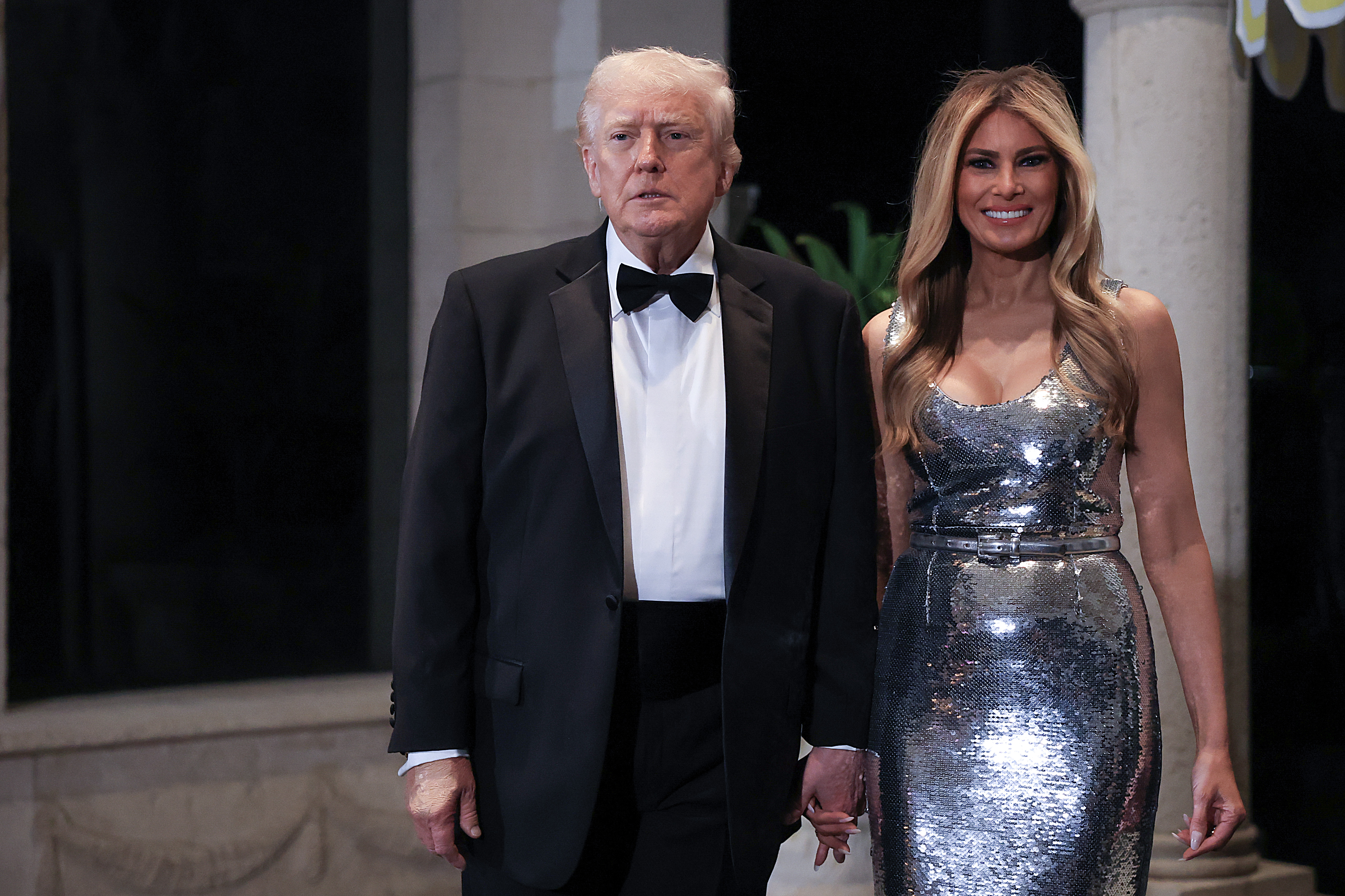 U.S. President Donald Trump and first lady Melania Trump arrive for a New Year’s Eve event at his Mar-a-Lago home on December 31, 2025 in Palm Beach, Florida. | Source: Getty Images