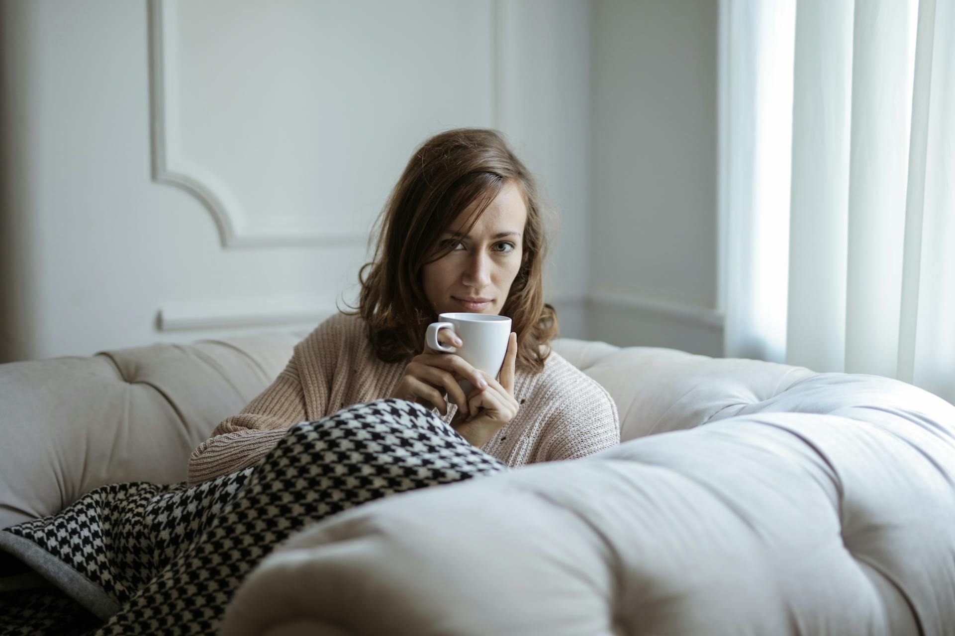 A woman on an armchair staring at someone | Source: Pexels