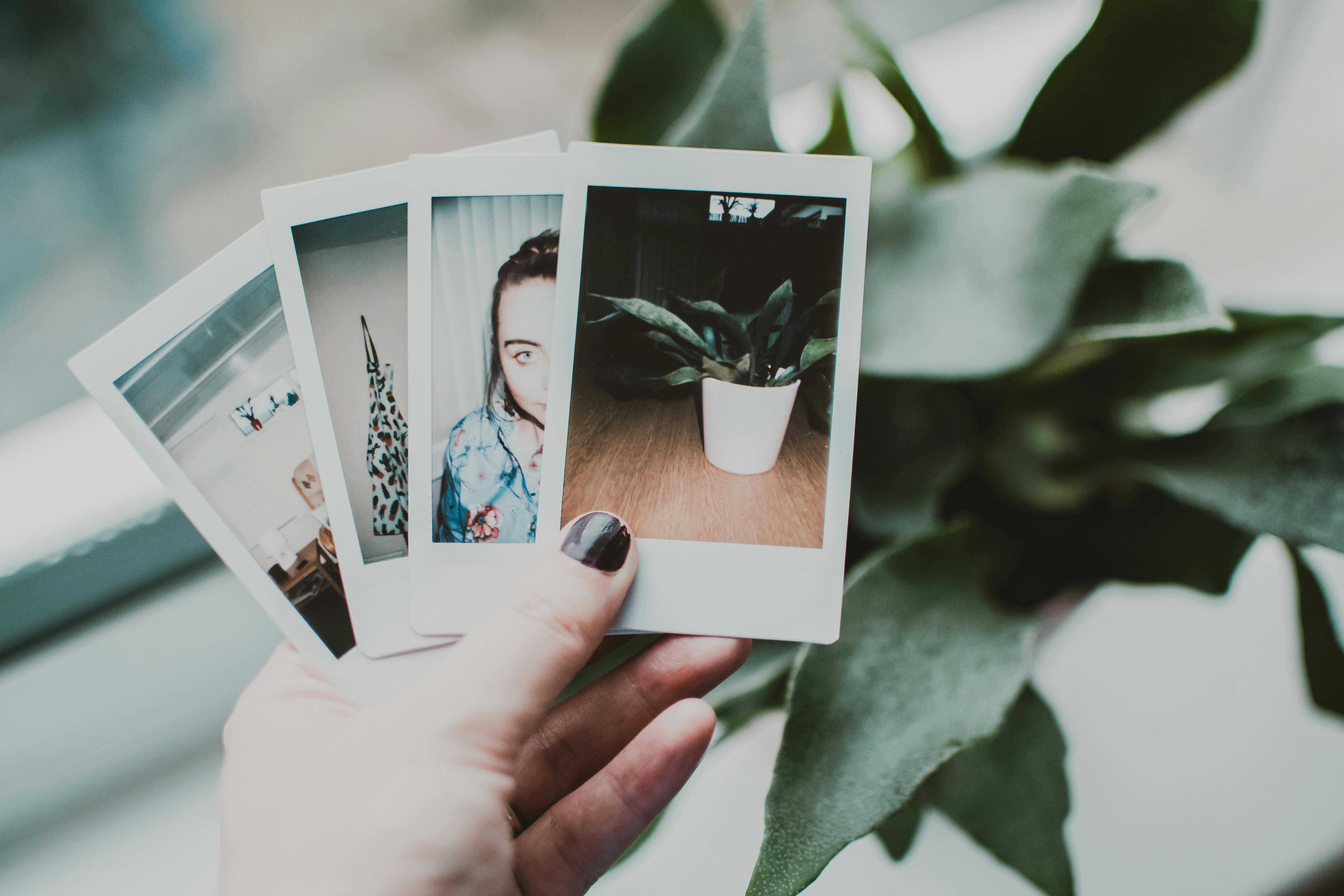 A person holding polaroid photos | Source: Pexels