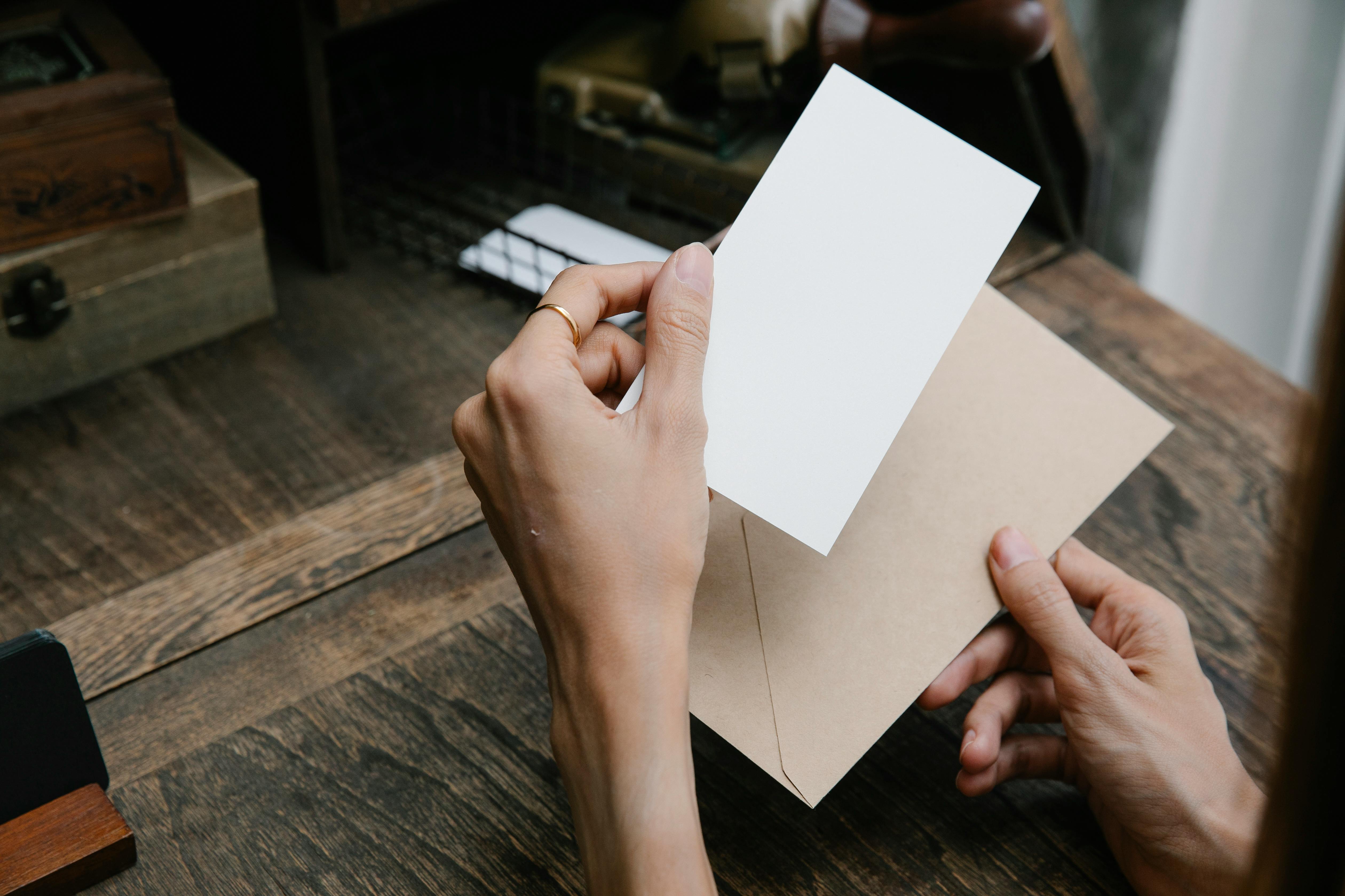 A person holding a piece of paper and an envelope | Source: Pexels